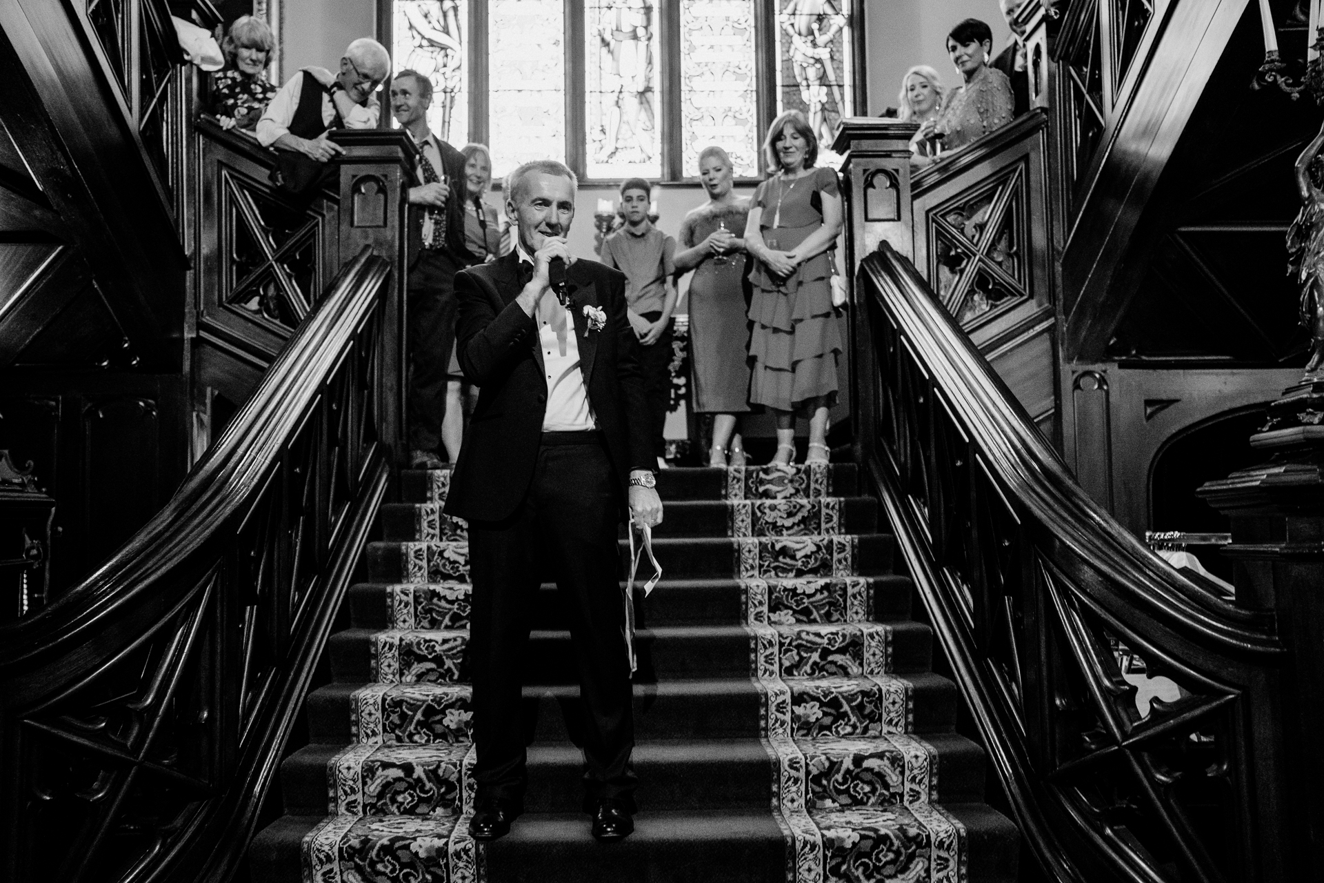 A person in a suit and tie walking down a flight of stairs