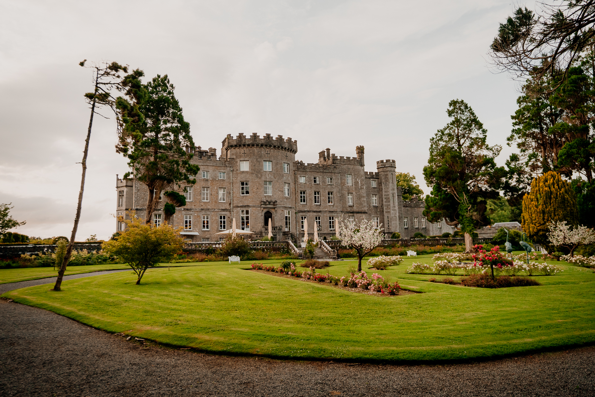 A large building with a lawn and trees in front of it