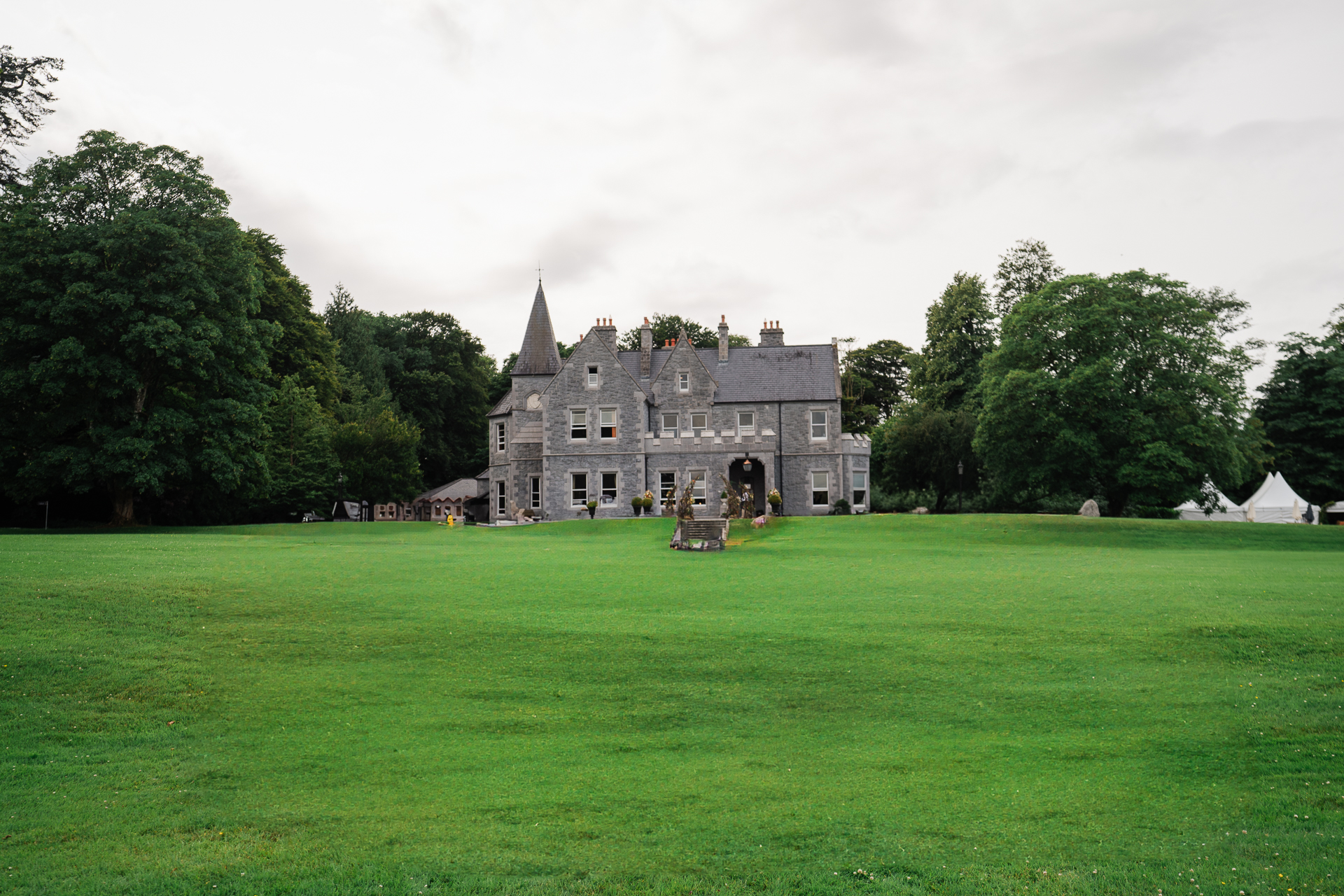 A large green field with a building in the background