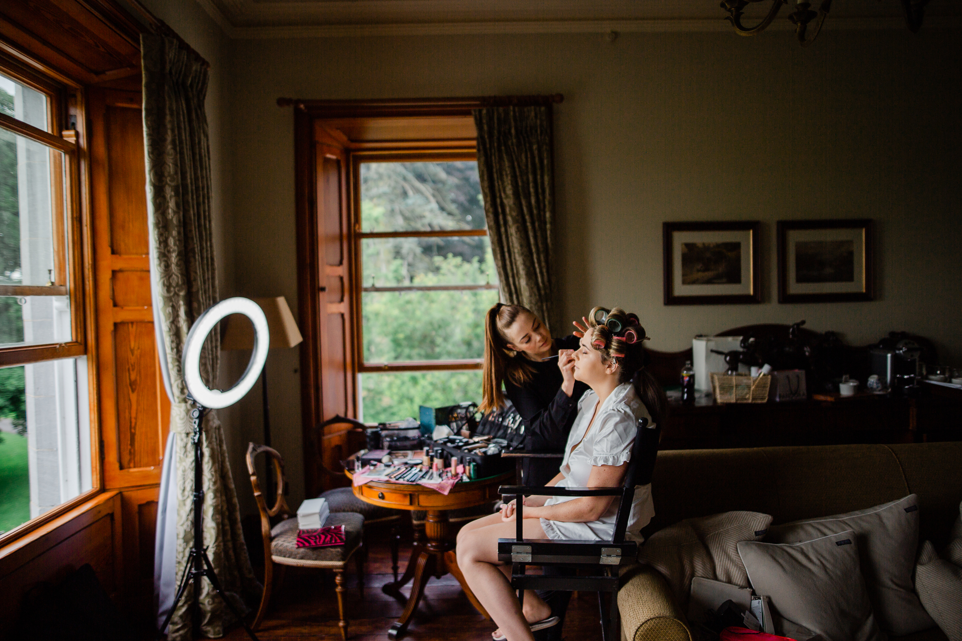 A couple of women sitting at a table in a living room