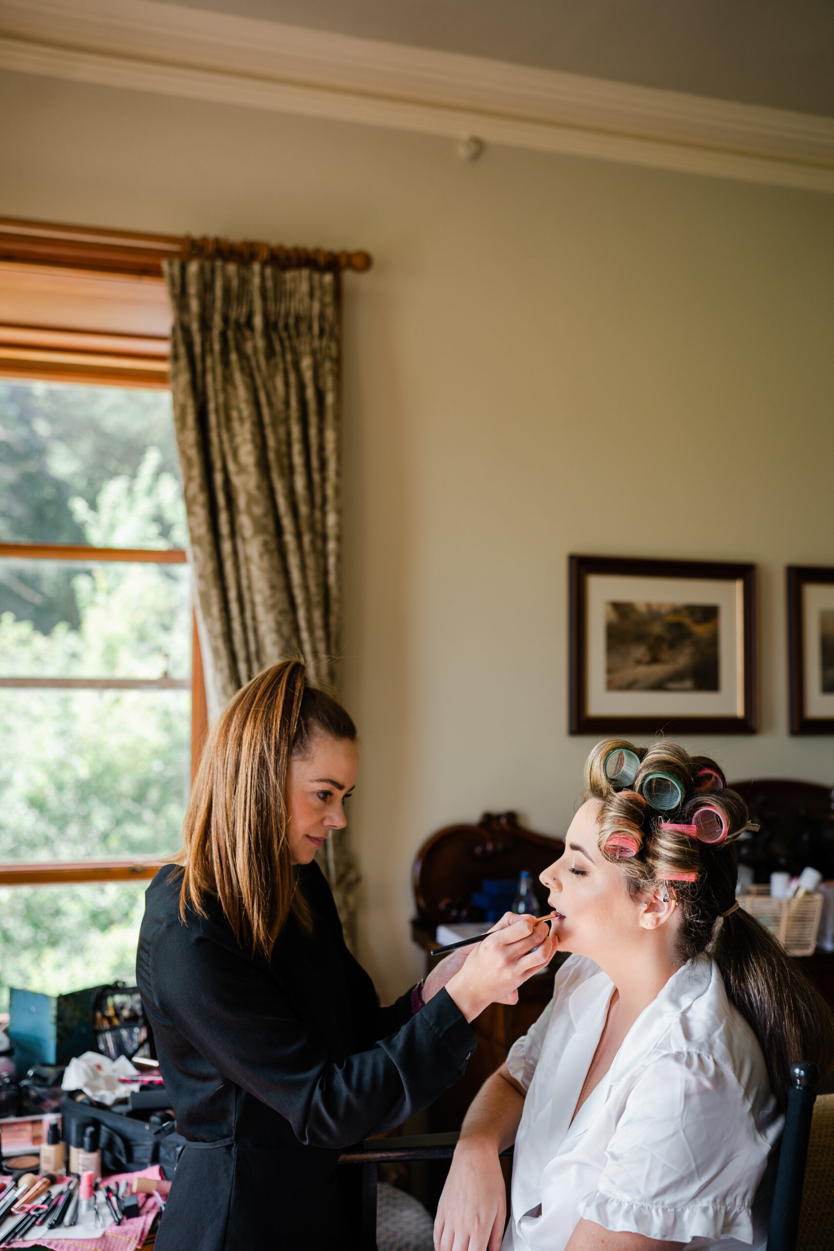 A woman cutting another woman's hair