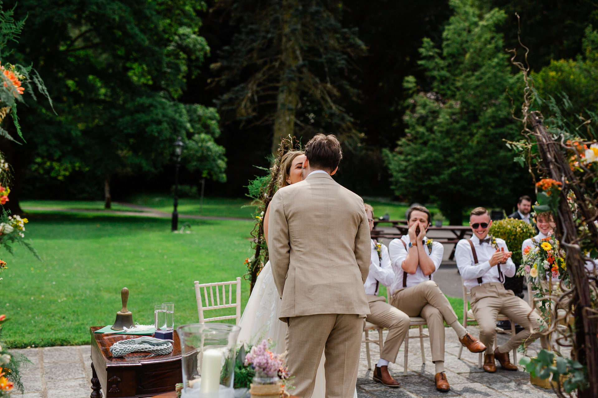 A person talking to a group of people sitting on a bench