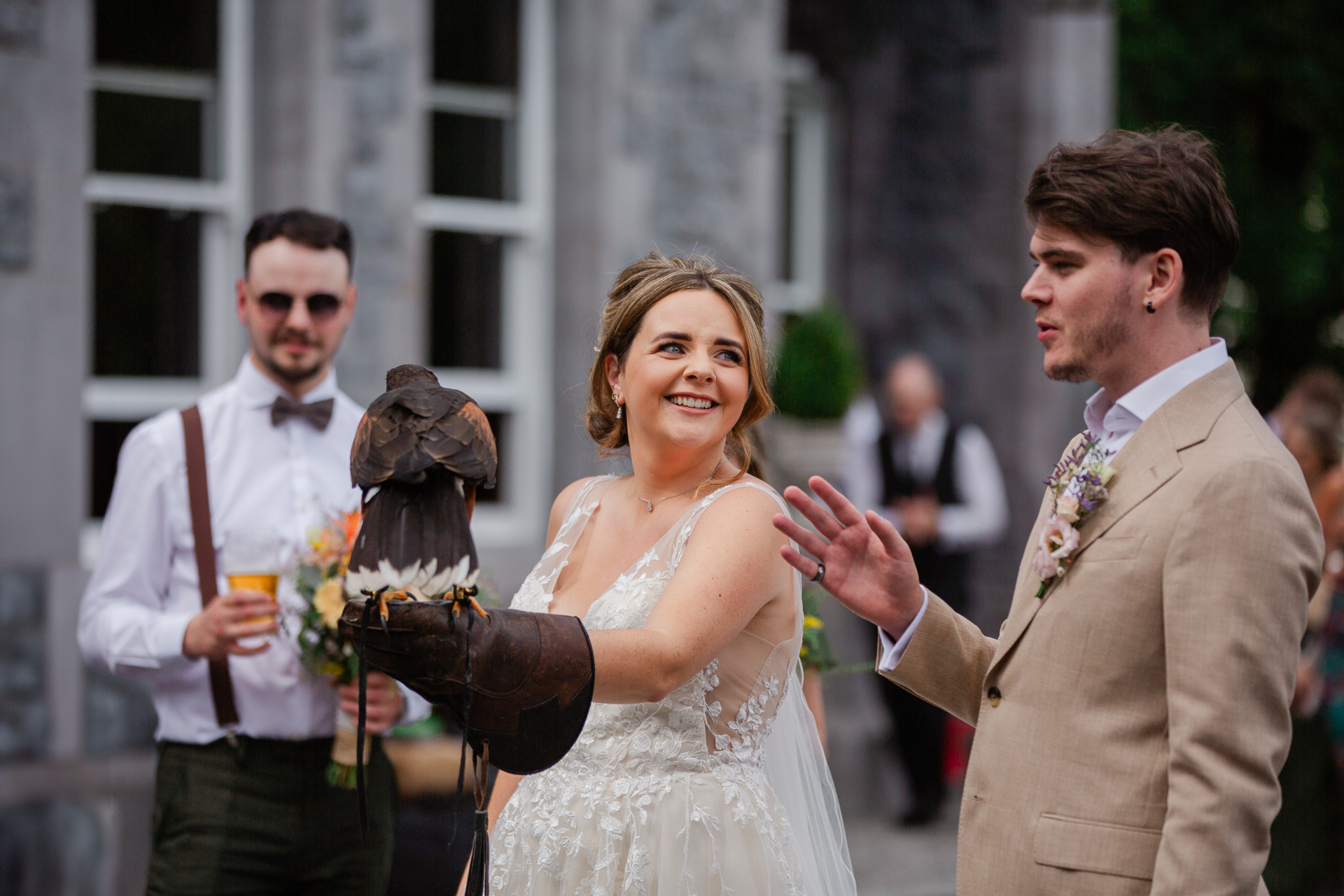 A bride and groom holding a bird