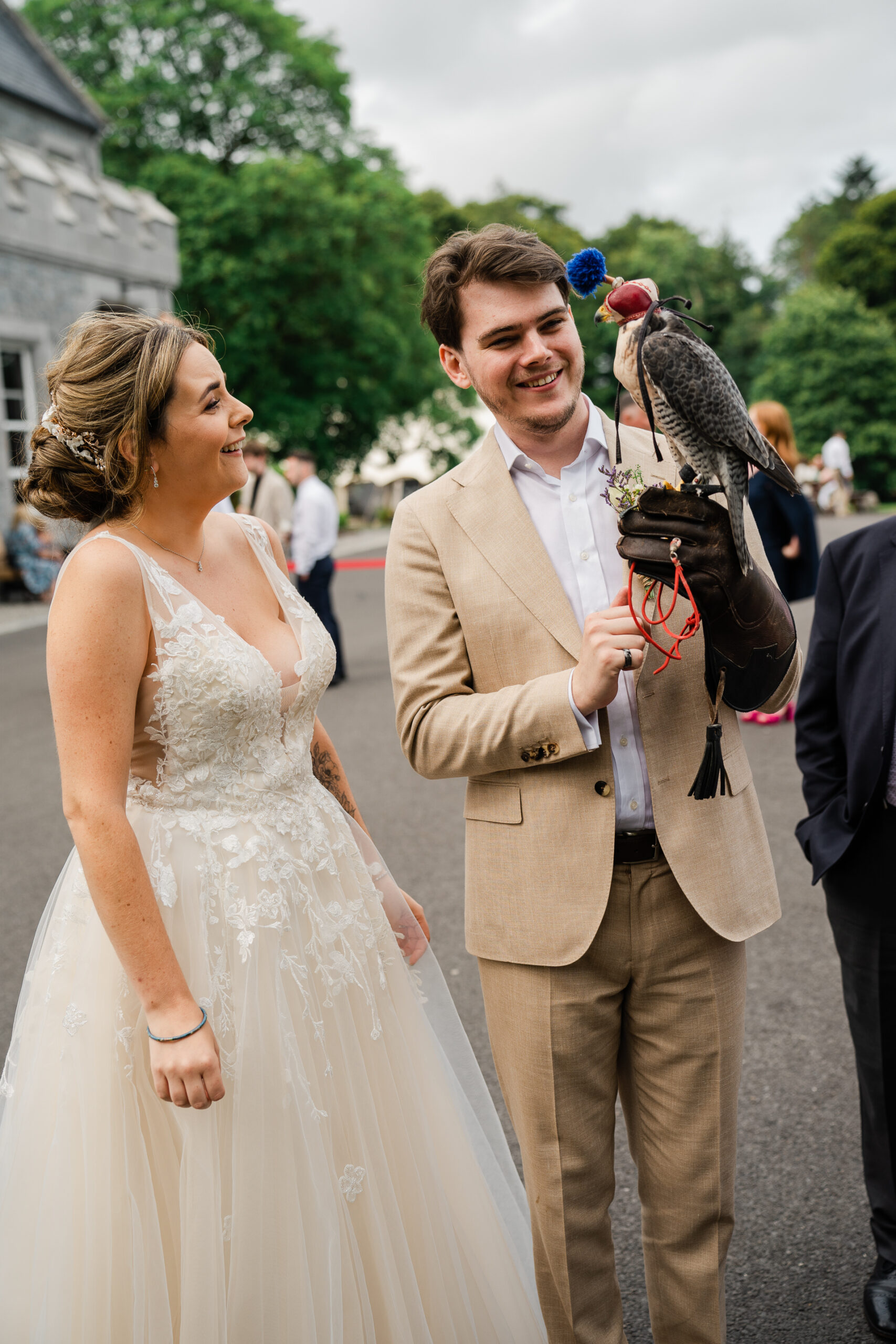 A man and woman holding a bird