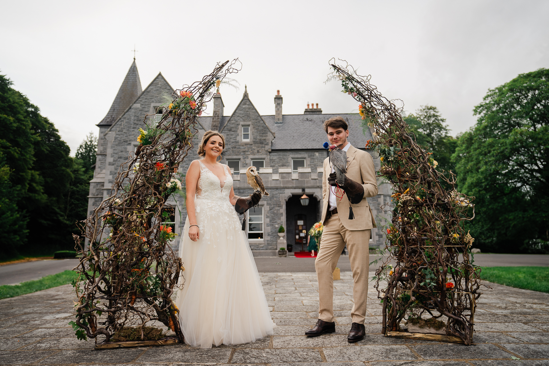 A man and woman posing in front of a house