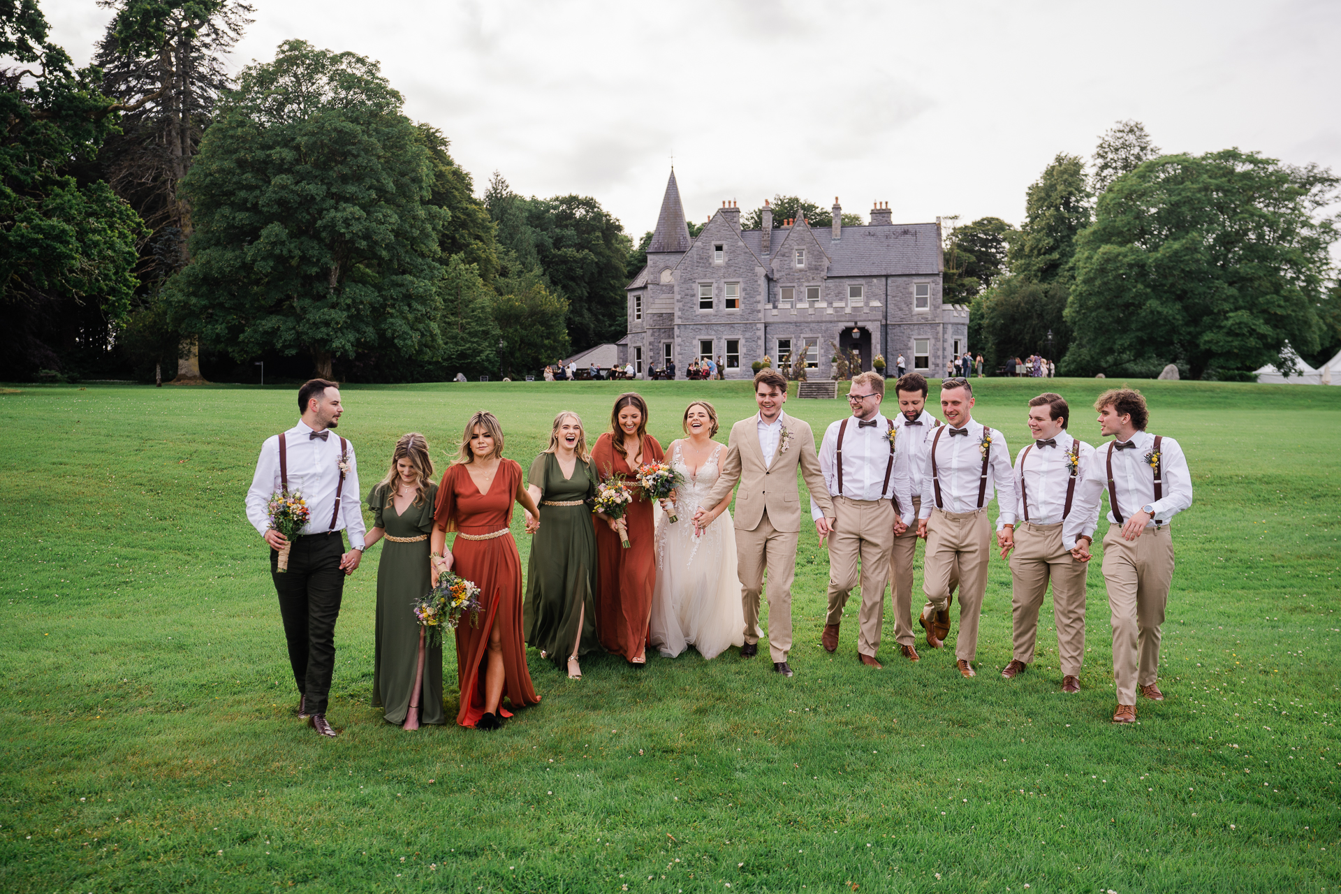 A group of people posing for a photo in front of a castle