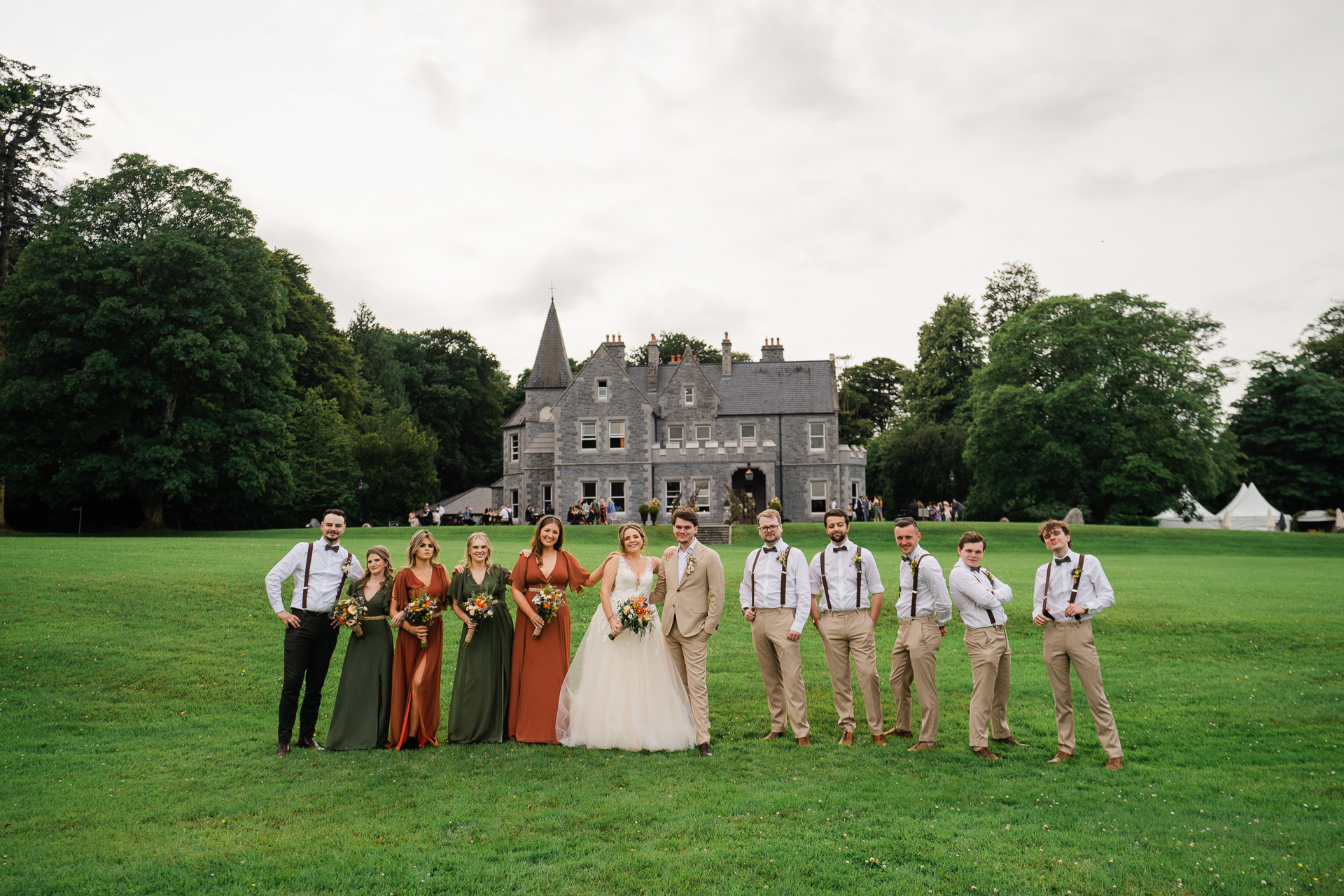 A group of people posing for a photo in front of a castle