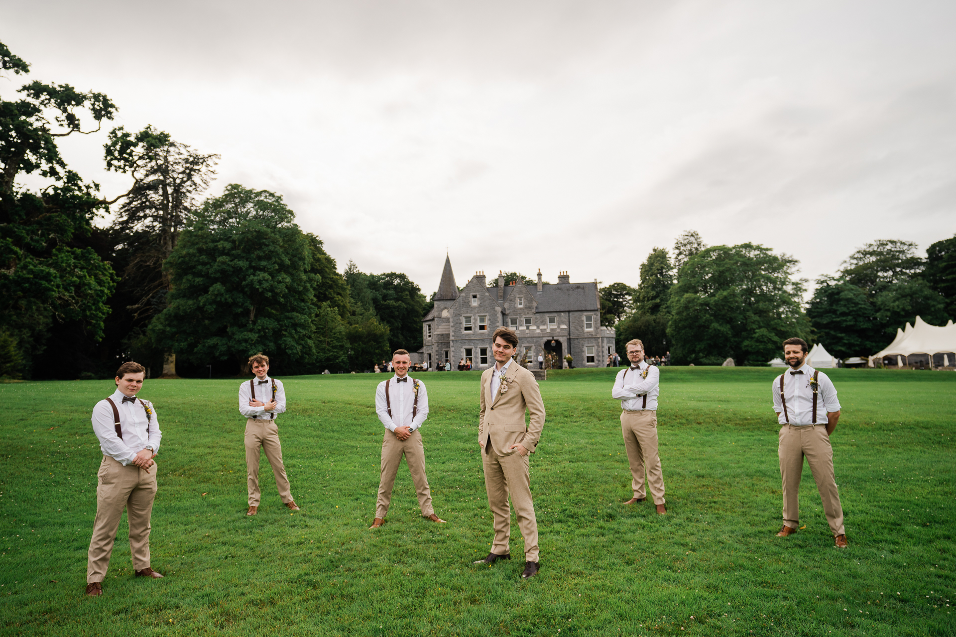 A group of people standing on grass