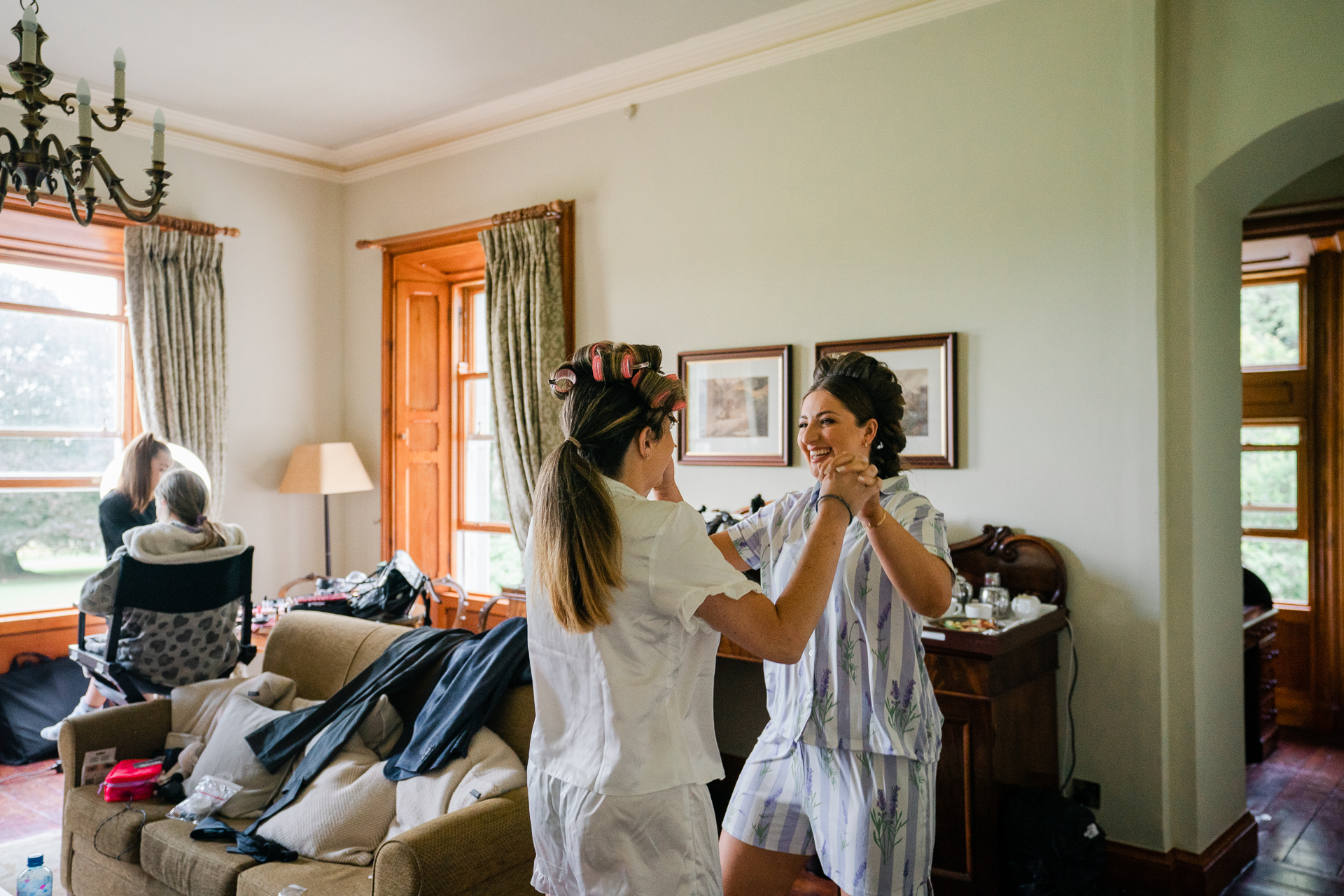 A man and woman dancing in a room with other people