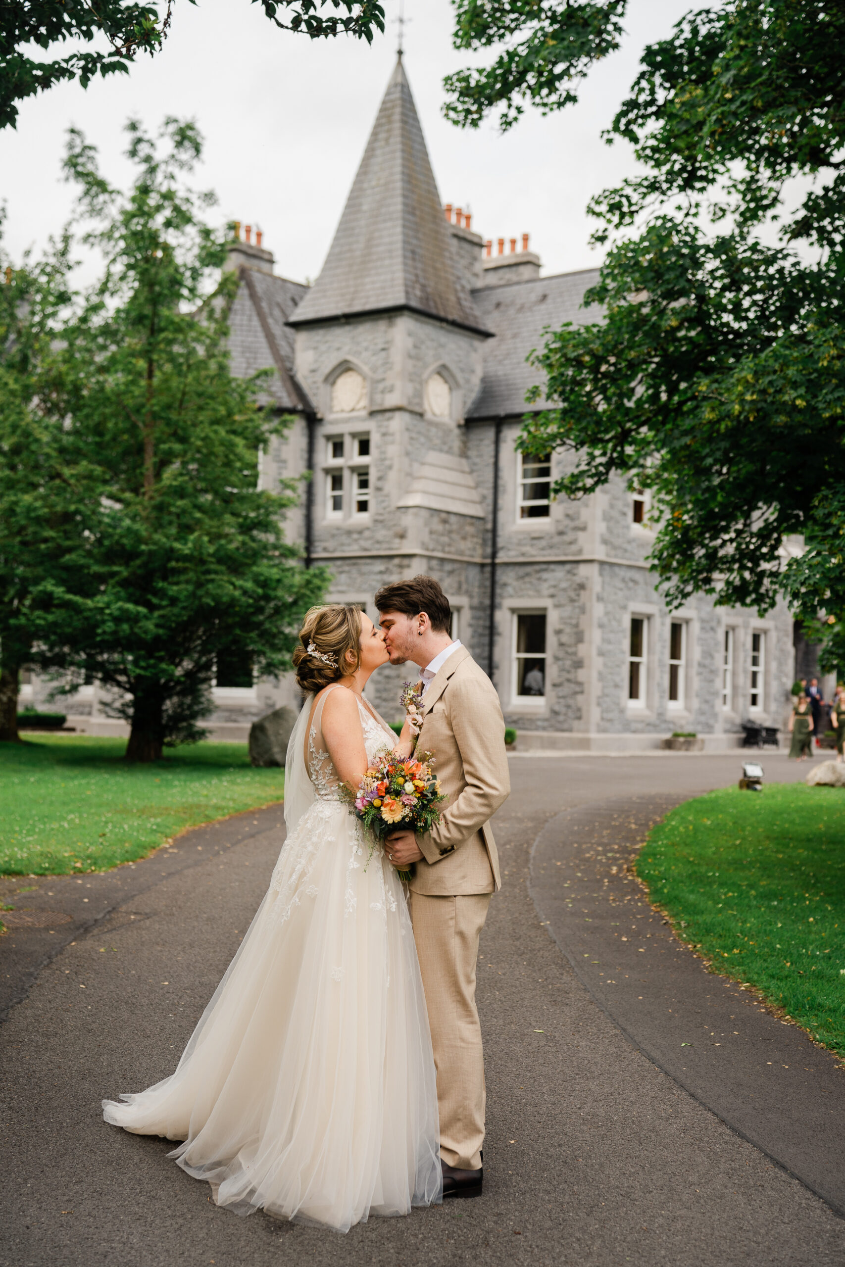 A man and woman kissing in front of a building