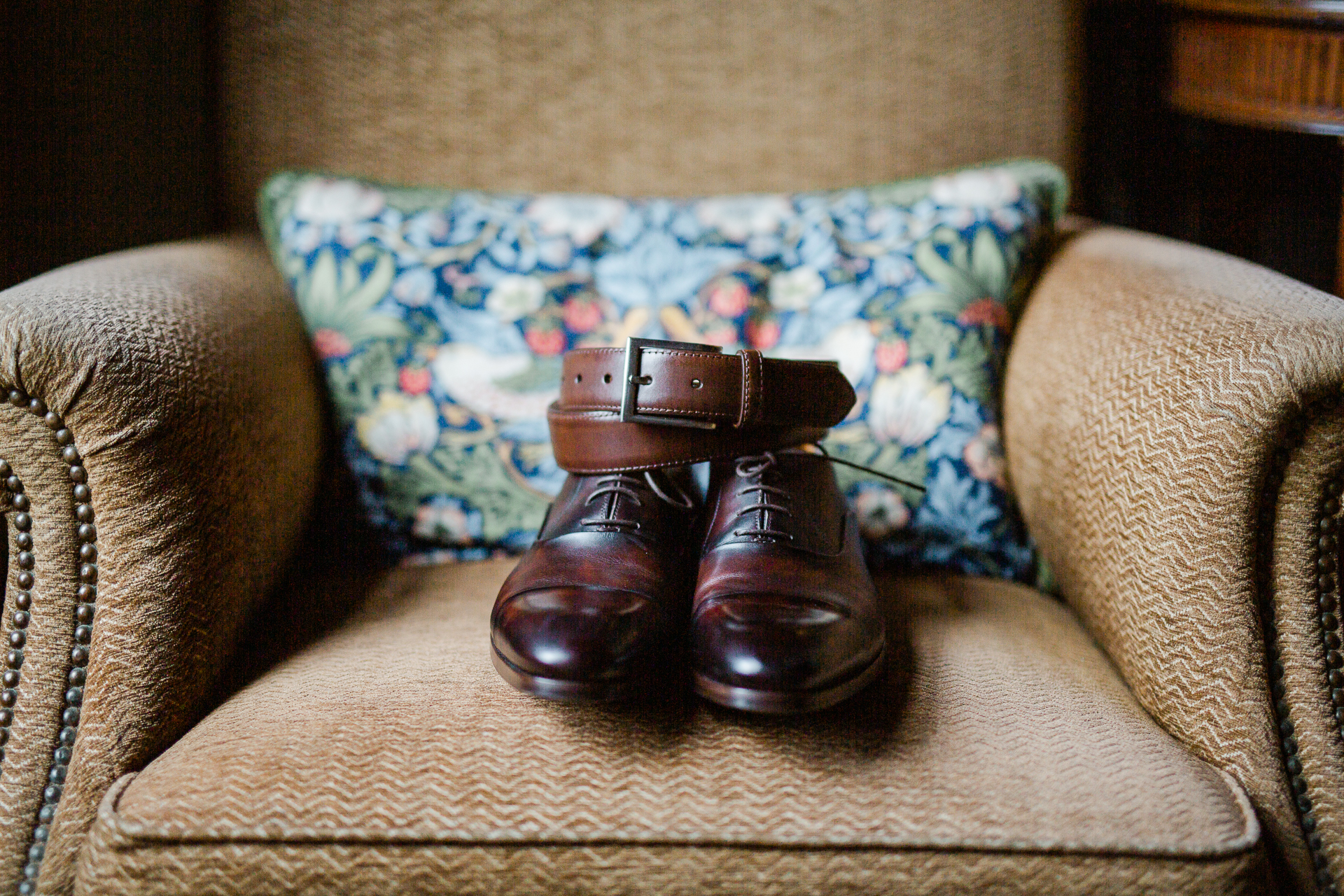 A pair of brown shoes on a couch