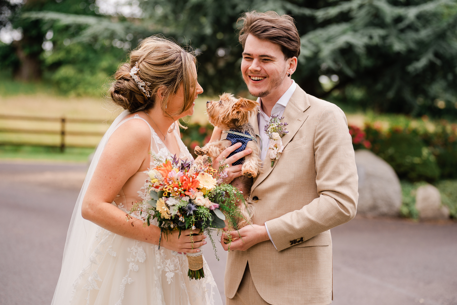 A man and woman holding a dog