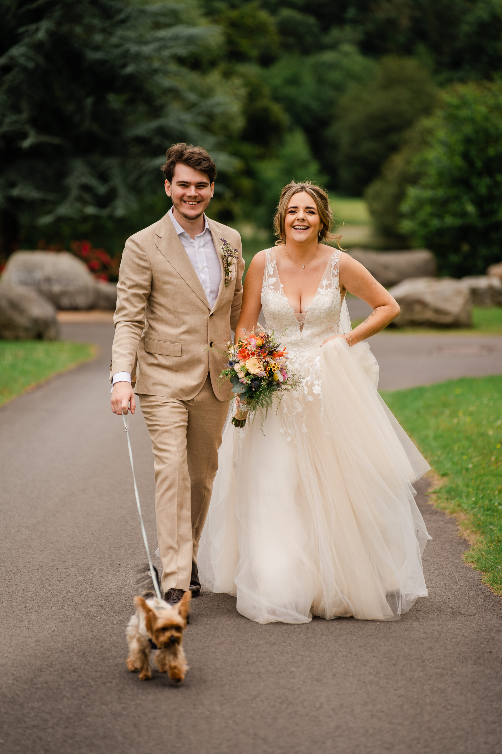 A man and woman walking a dog