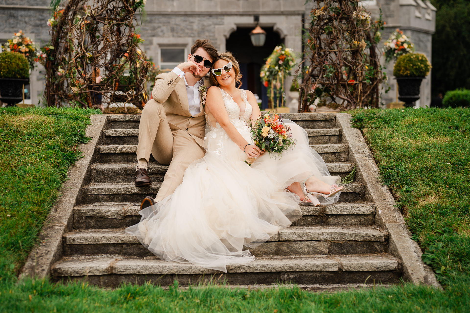 A man and woman posing for a picture on a stone staircase