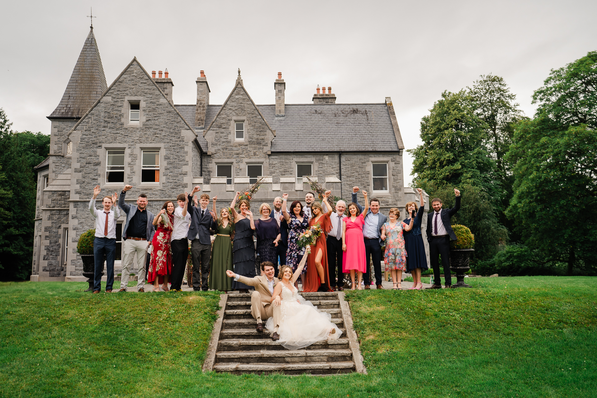 A group of people posing for a photo in front of a house