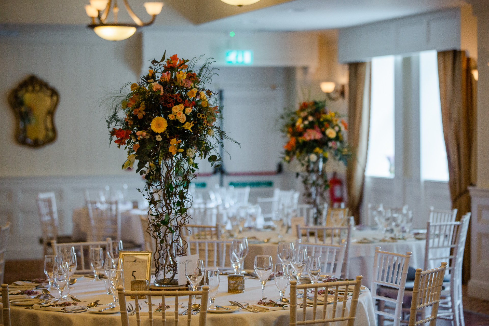 A large dining room with a large vase of flowers