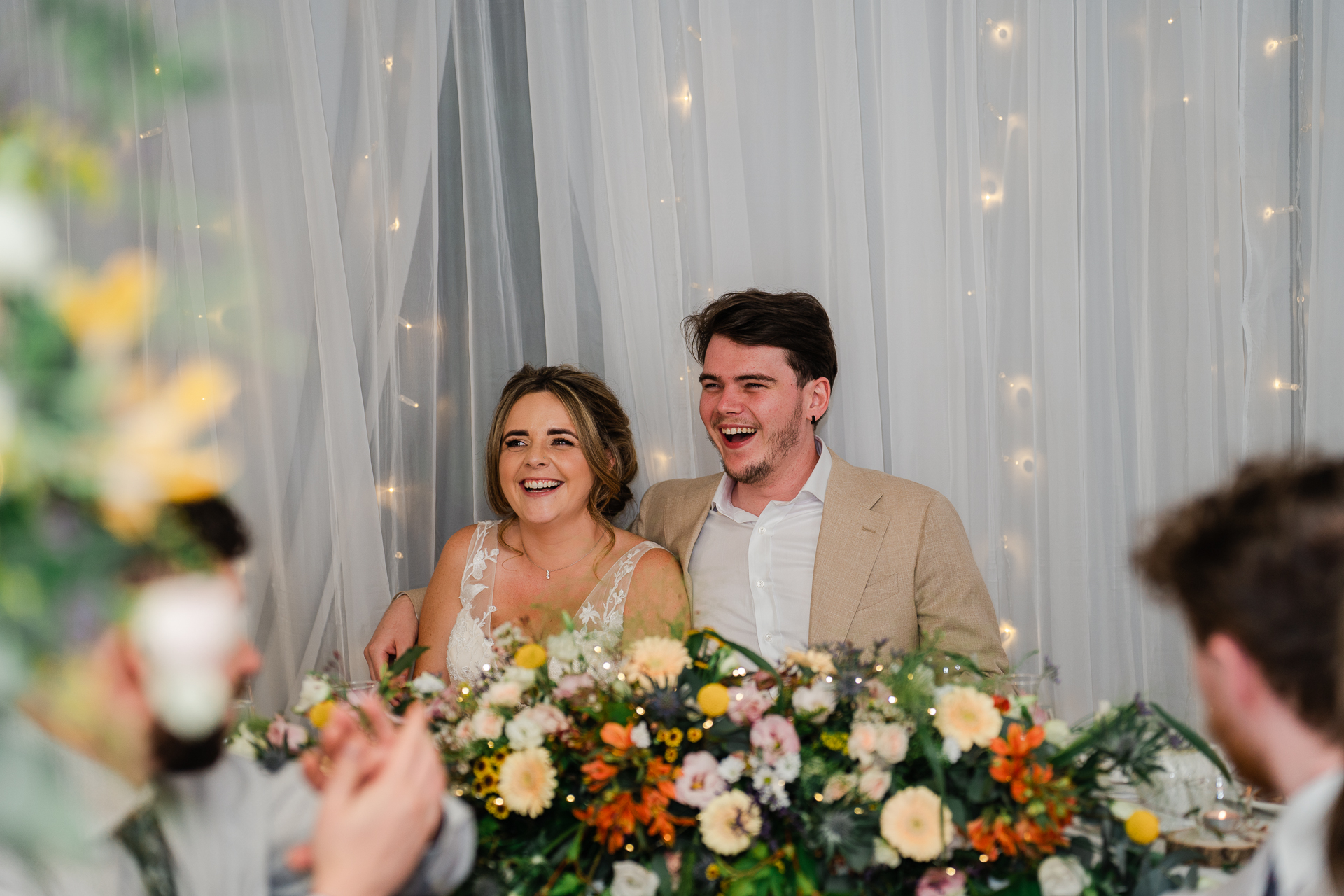 A man and woman holding flowers