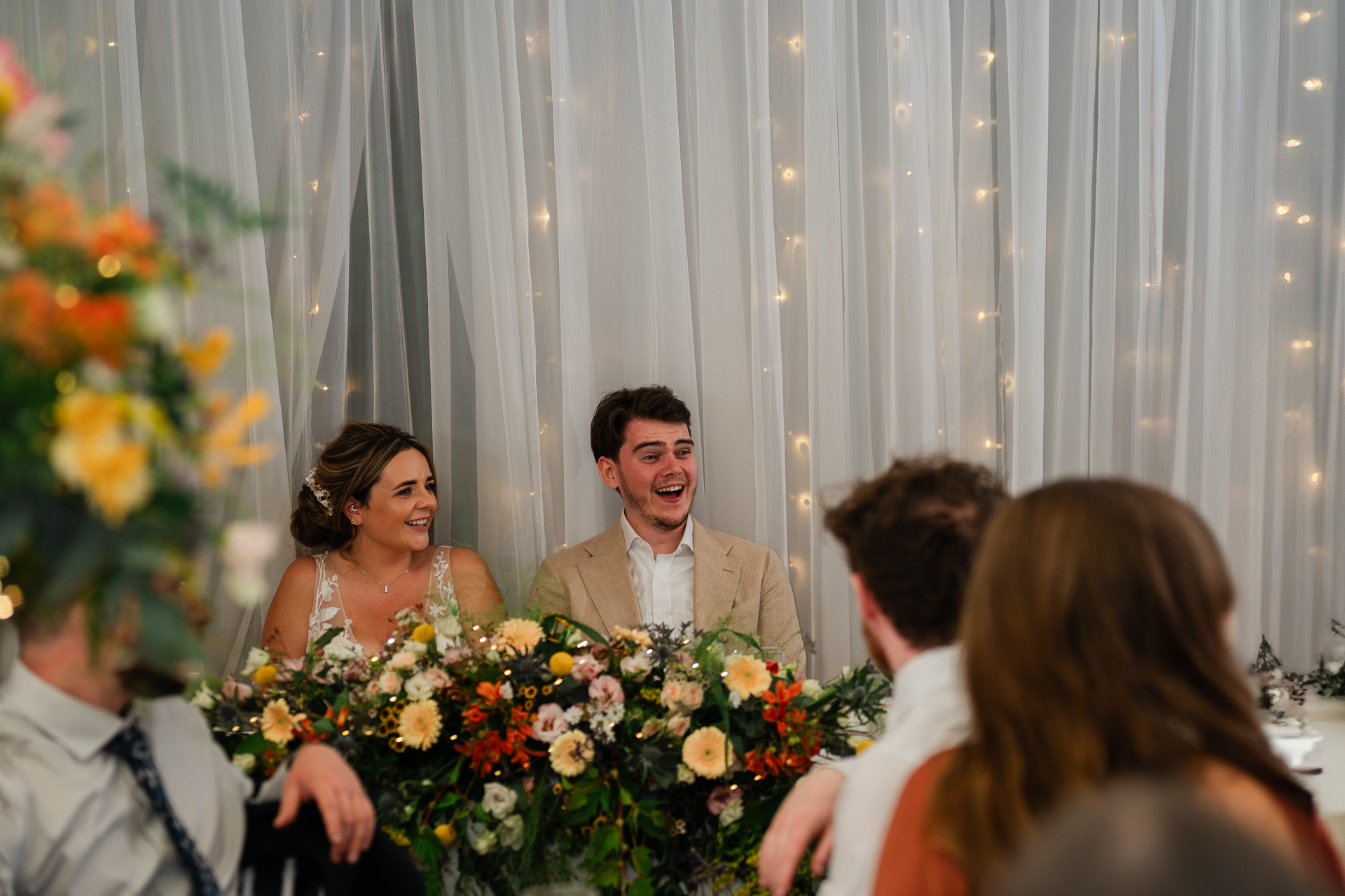 A man and woman holding flowers