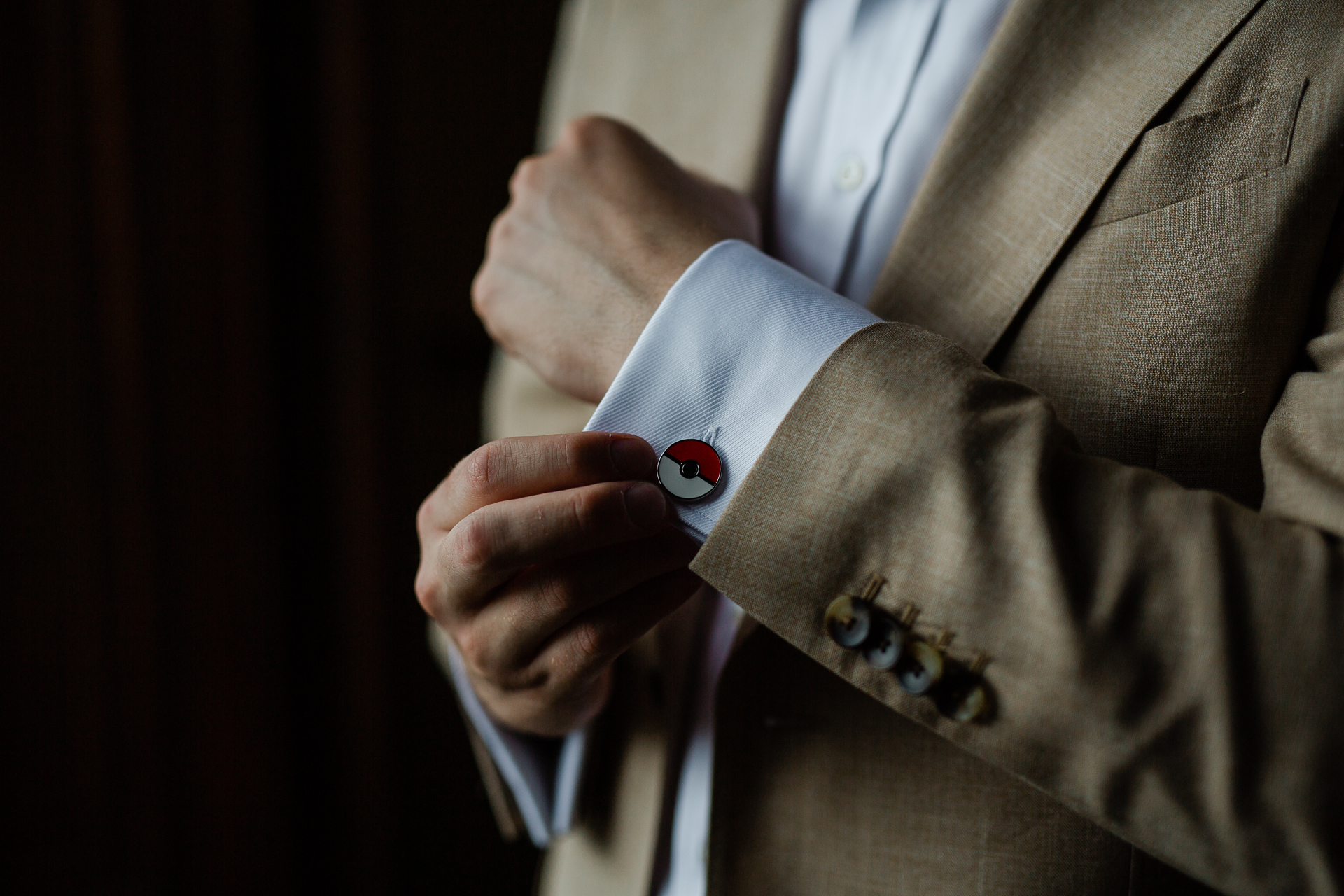 A man in a suit holding a white card