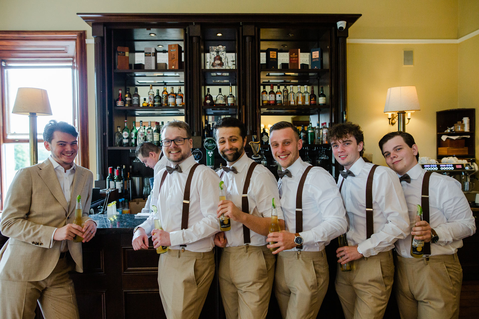 A group of men holding beer bottles