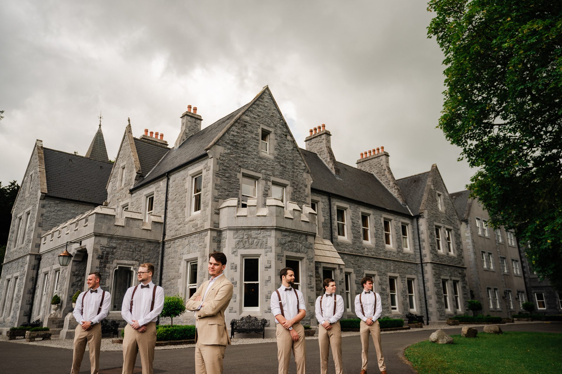 A group of men standing in front of a large building