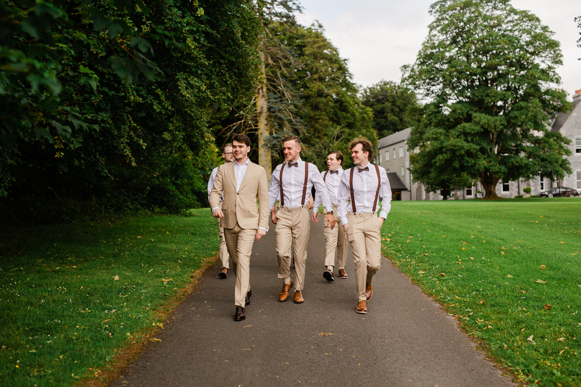 A group of men walking down a path in a park