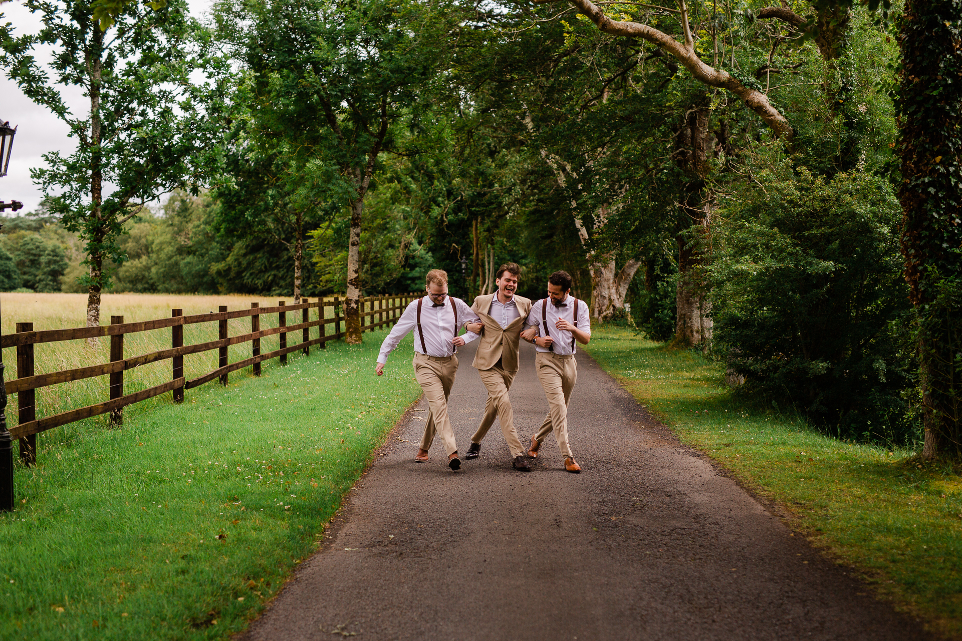 A group of men walking on a path in a park