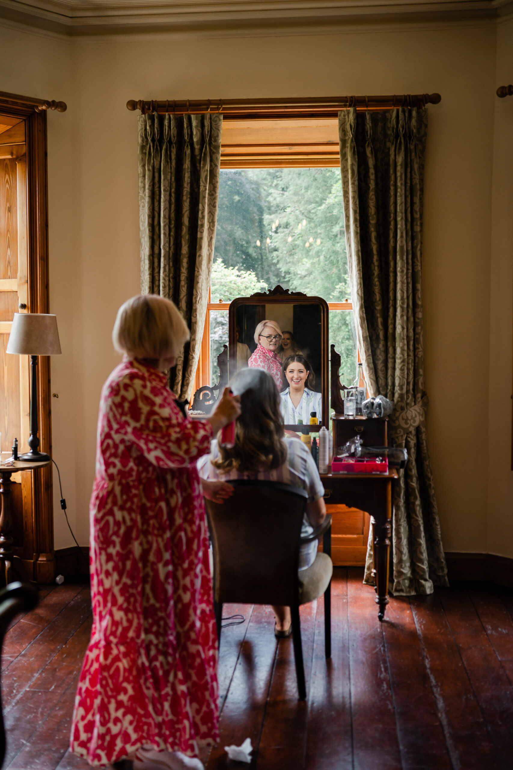 A person taking a picture of a person in a mirror