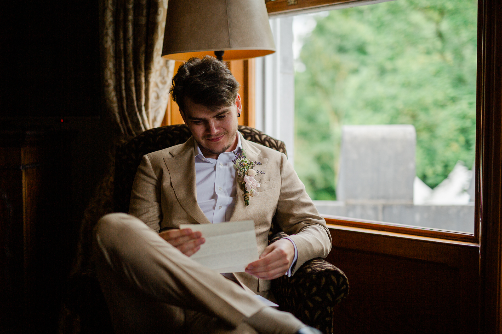 A man sitting in a chair reading a book