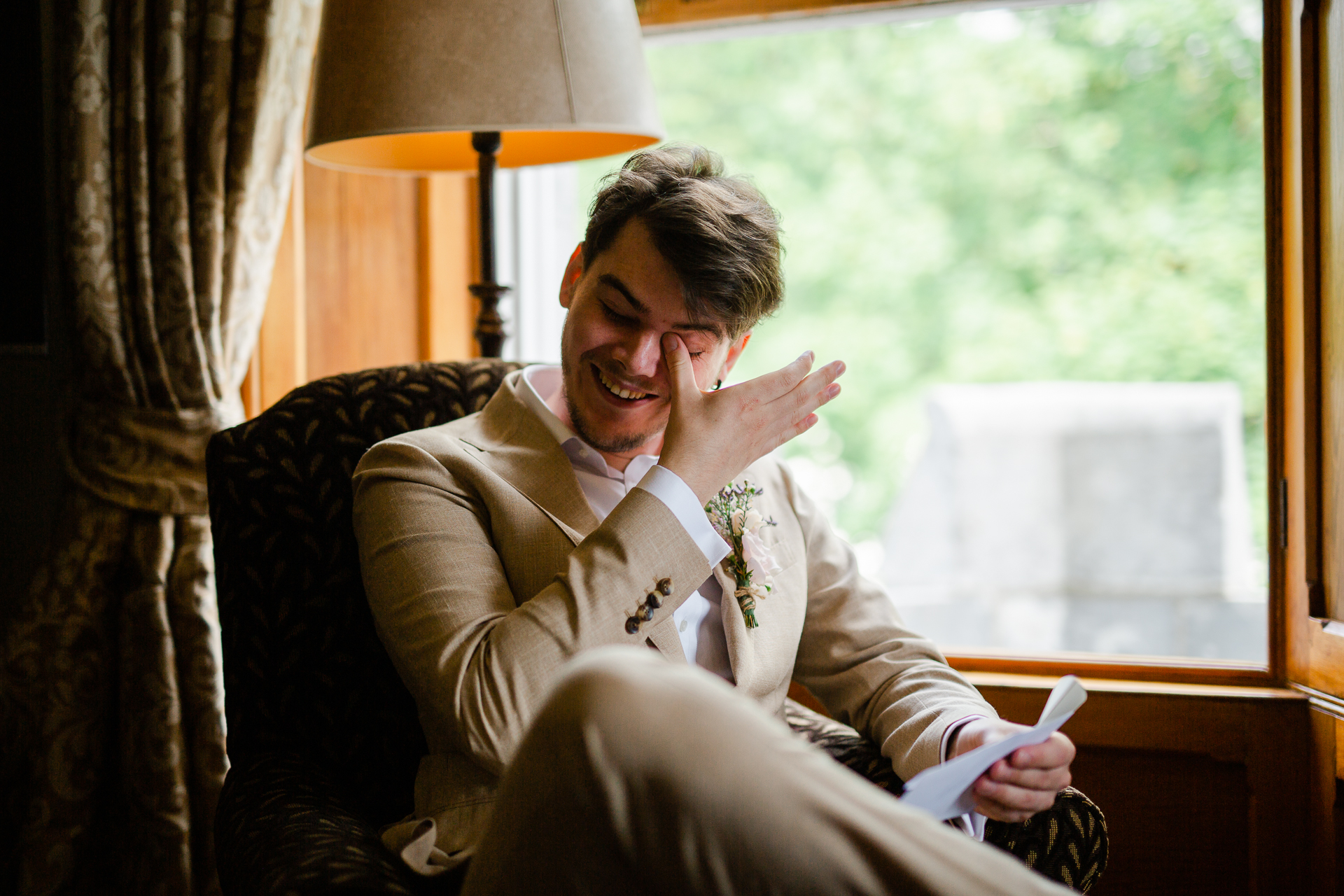 A man sitting in a chair and holding a paper