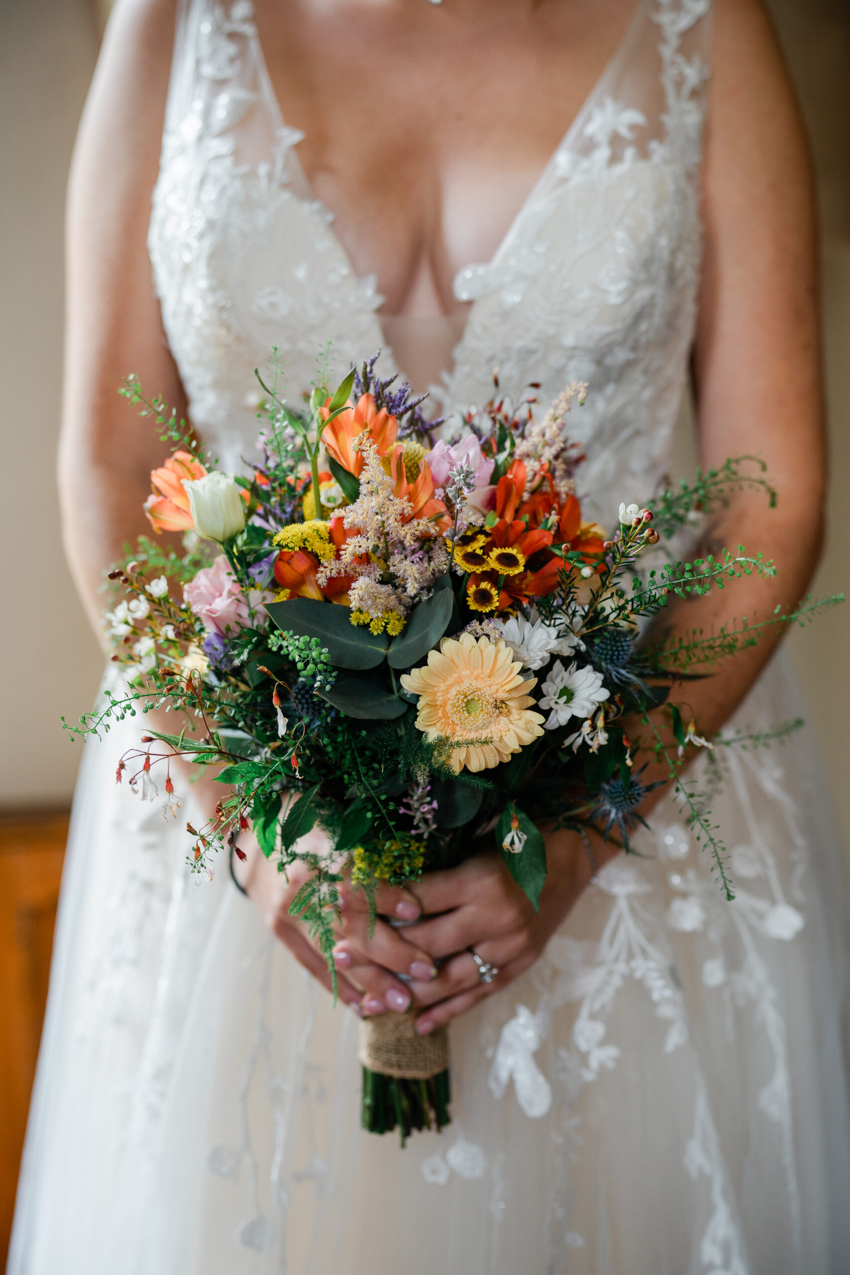 A woman wearing a white dress holding flowers