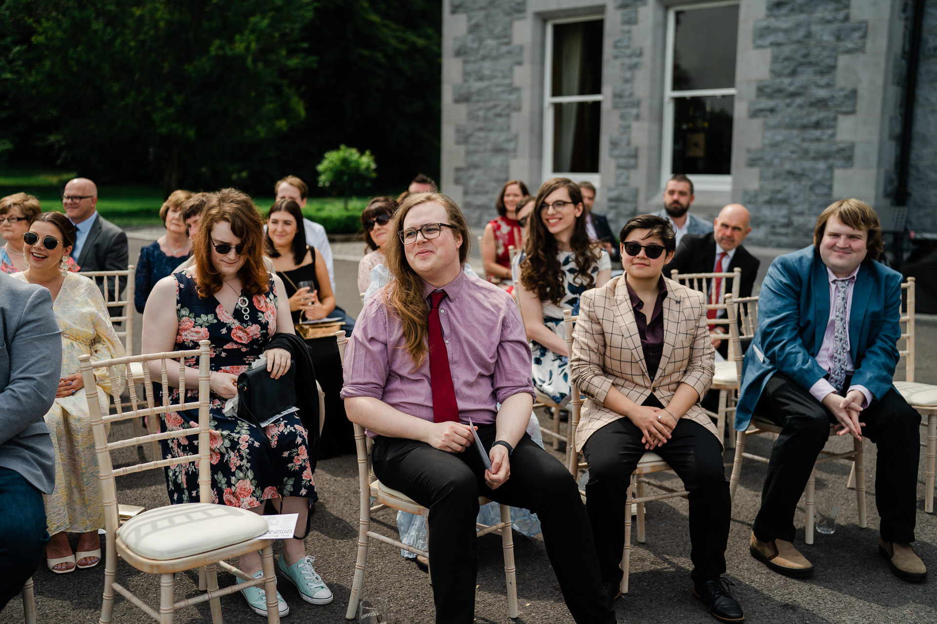 A group of people sitting outside