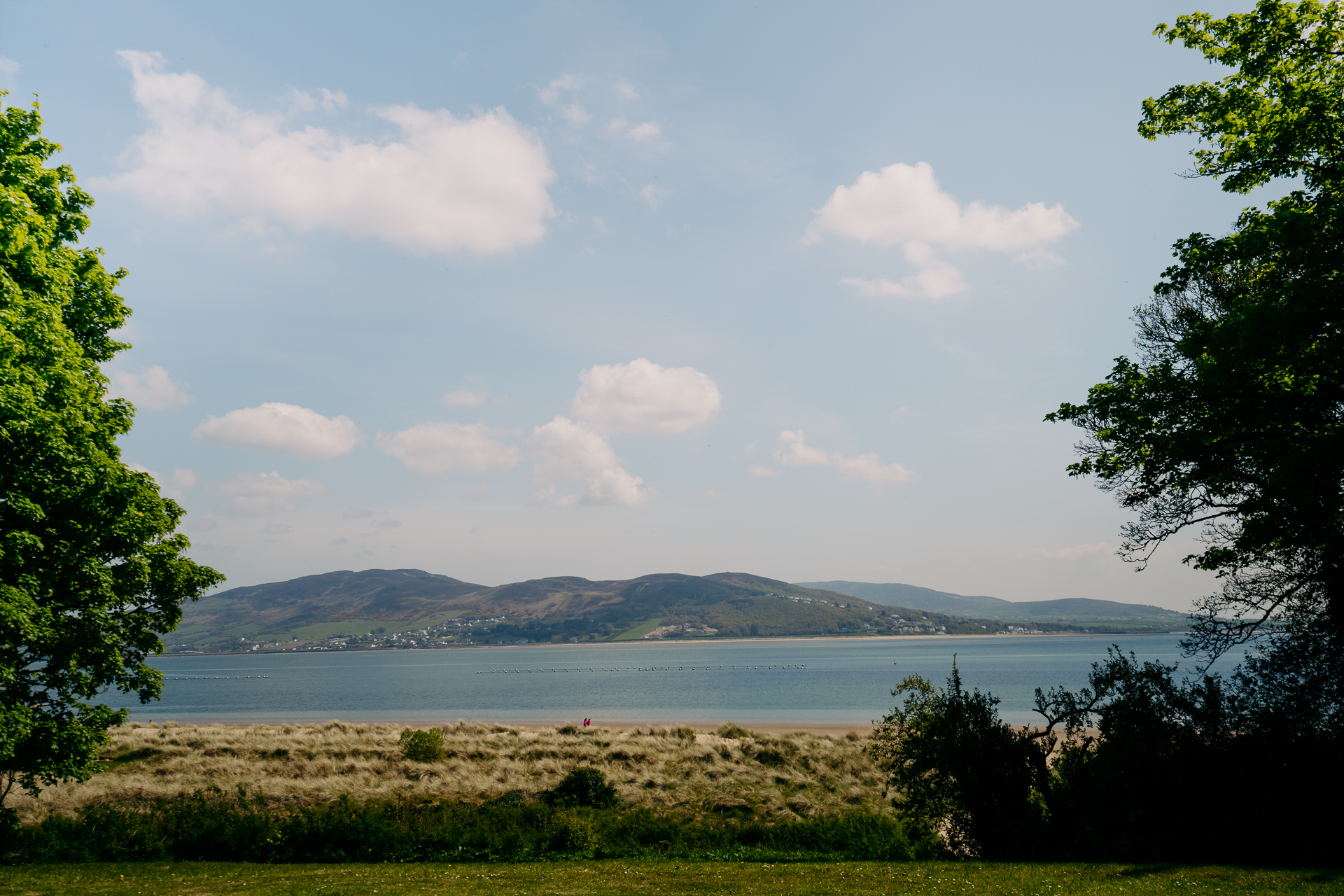 A body of water with hills in the background