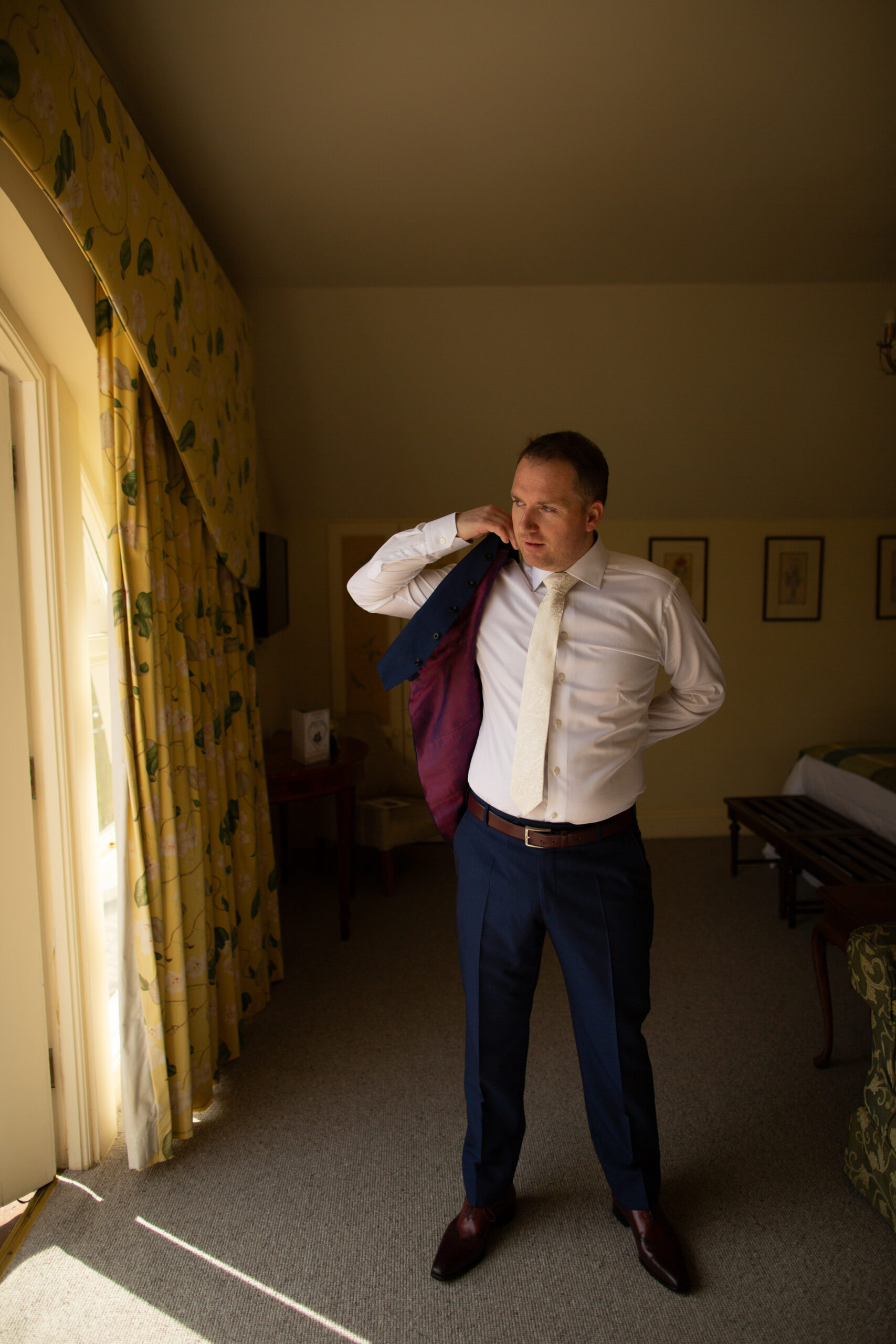 A man in a tie fixing his tie