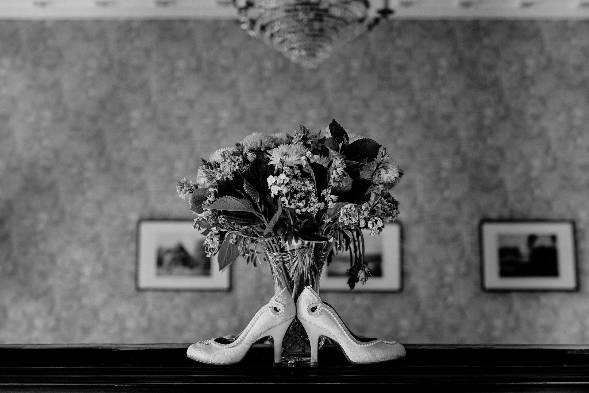 A black and white photo of a flower arrangement on a table