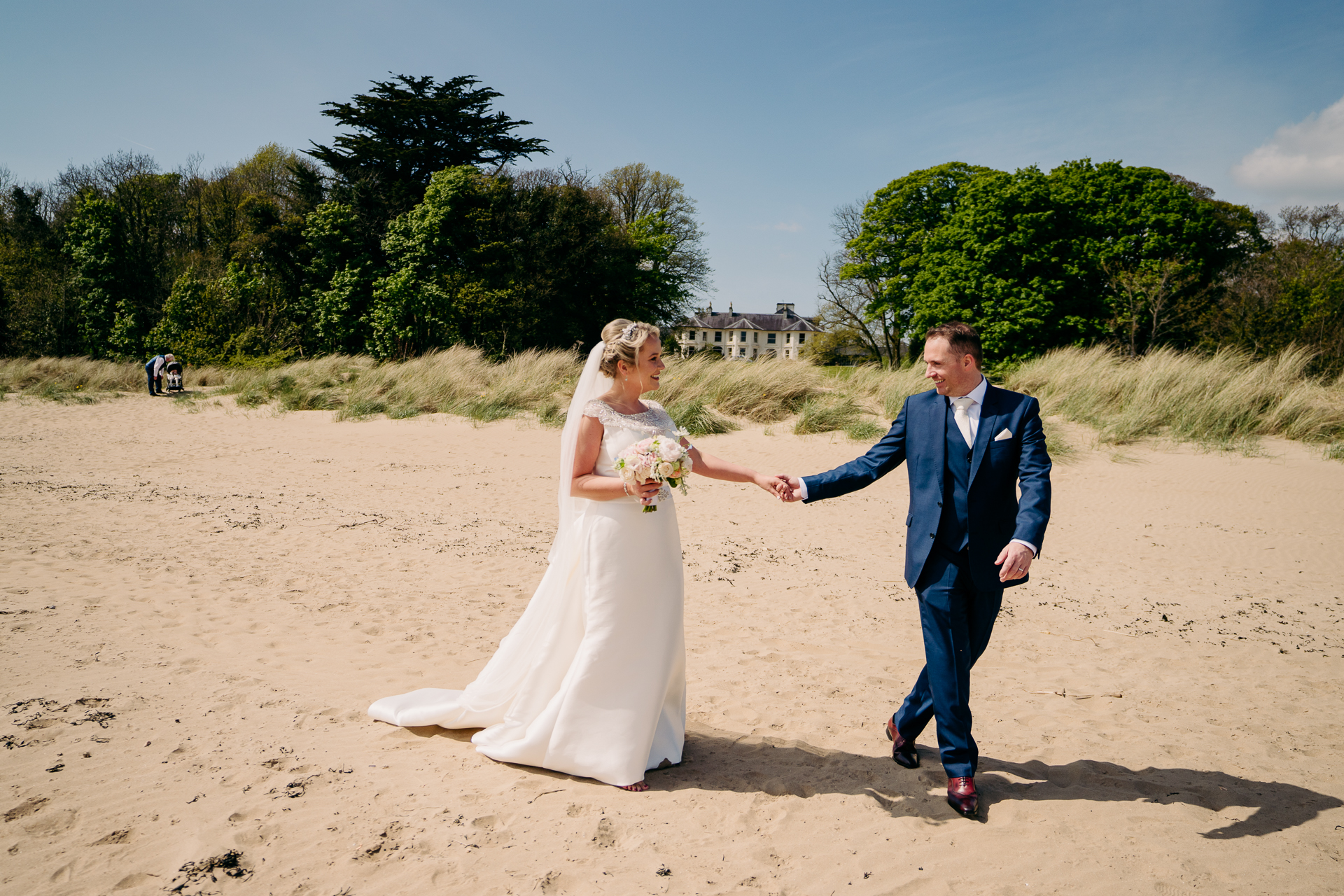 A man and woman walking on a beach