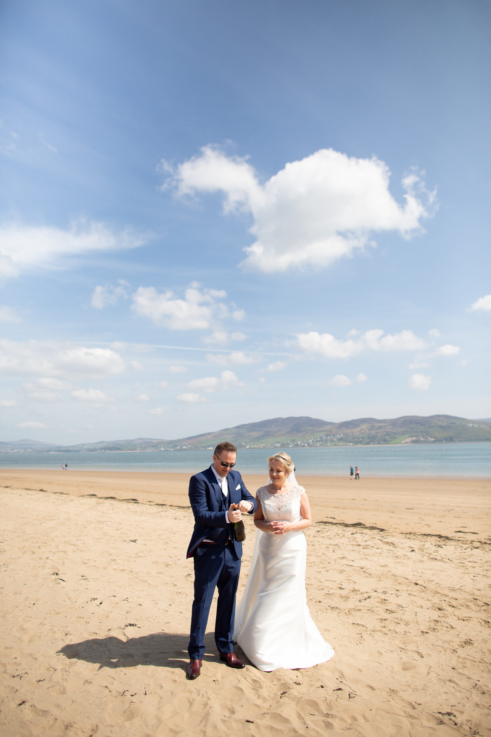 A man and woman posing on a beach