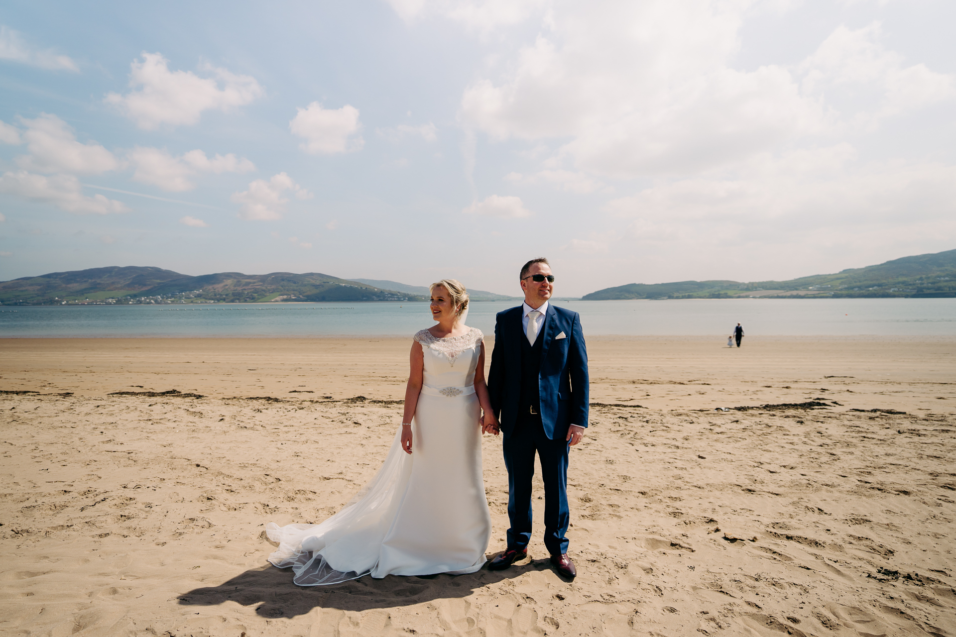 A man and woman posing on a beach