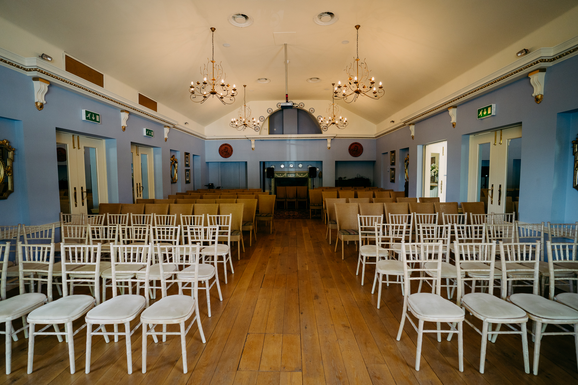 A room with rows of white chairs