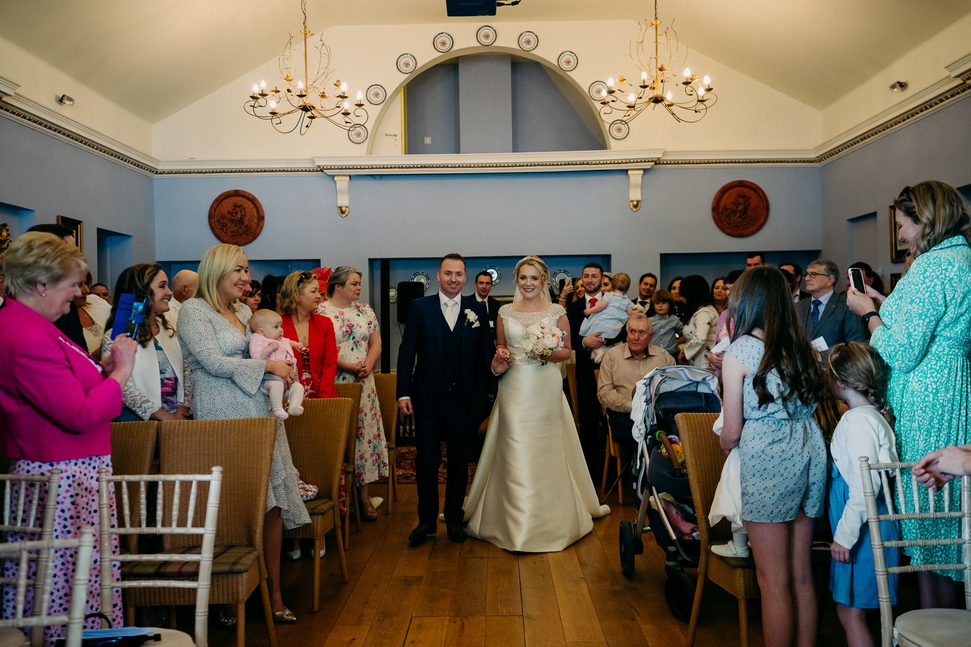 A bride and groom walking down the aisle