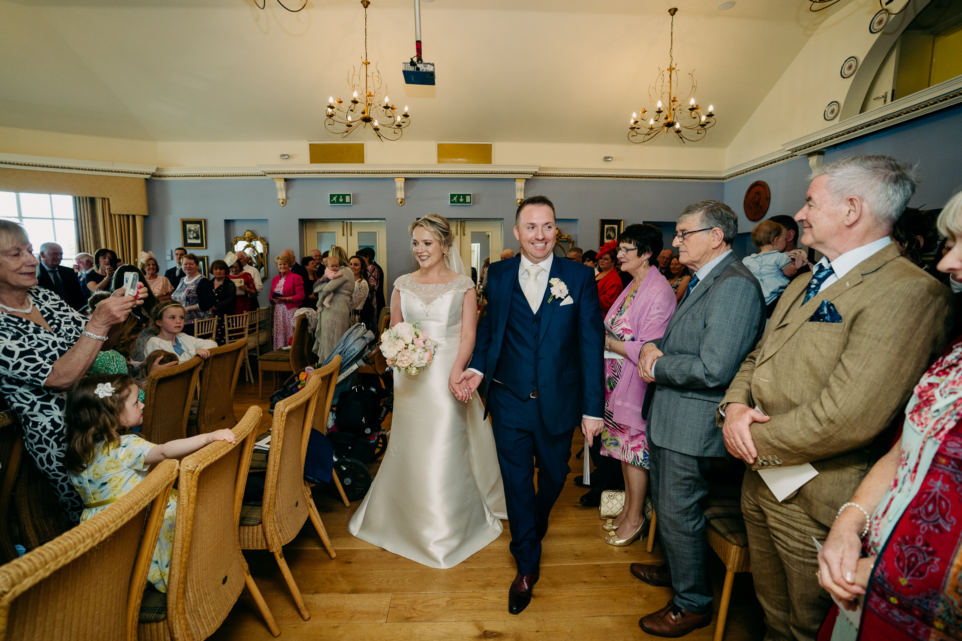 A bride and groom walking down the aisle