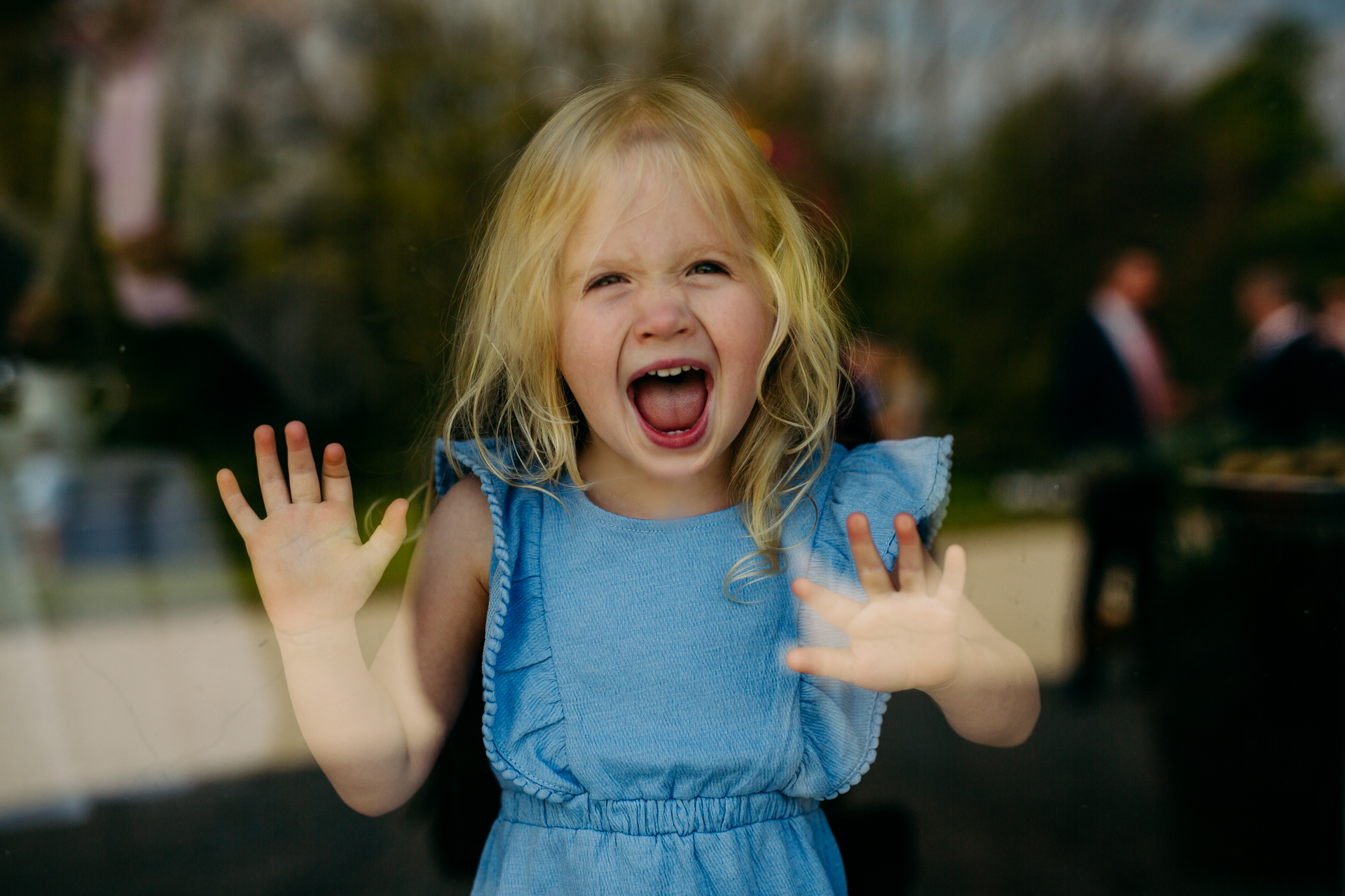 A little girl with her hands up