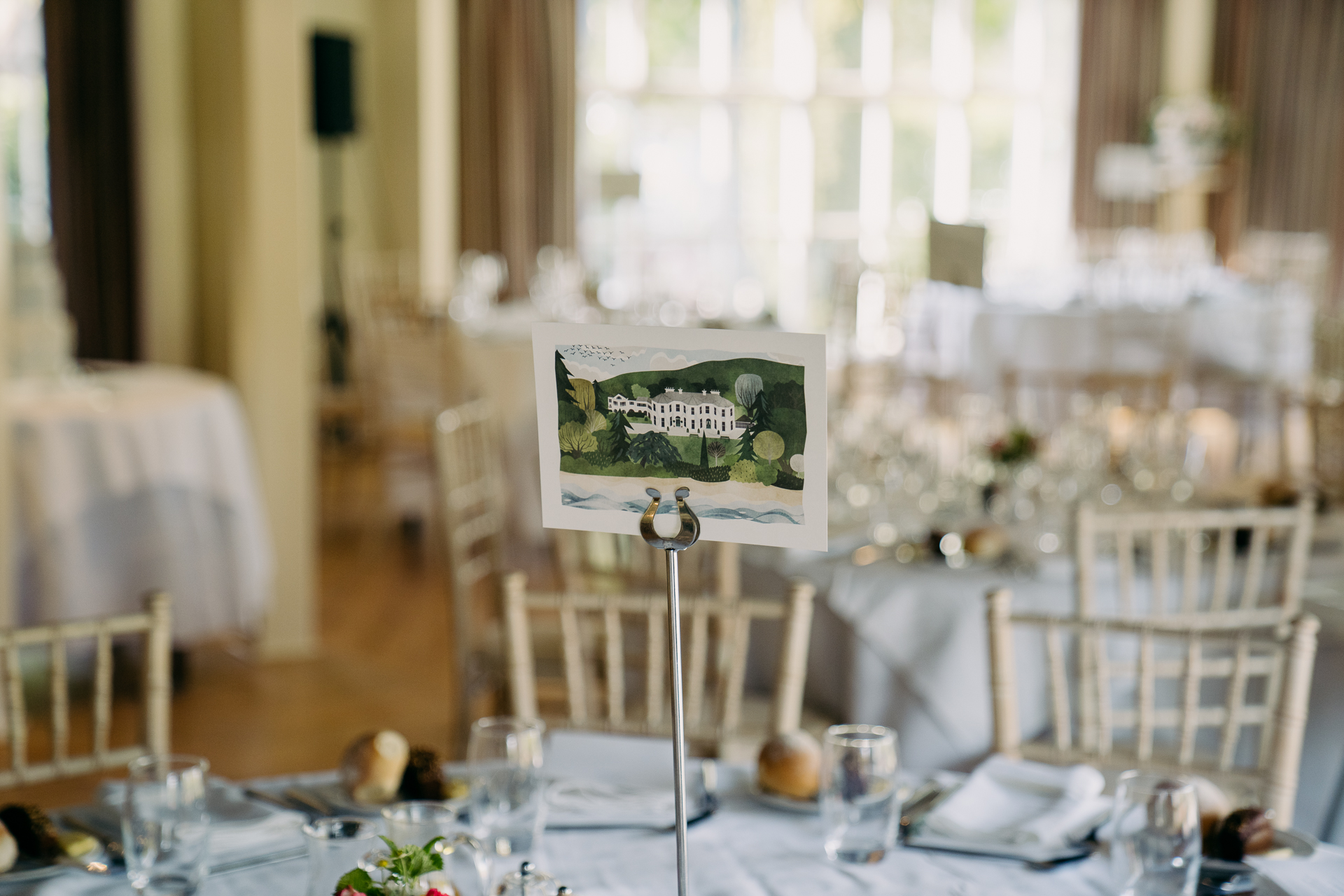 A table with a sign and glasses on it