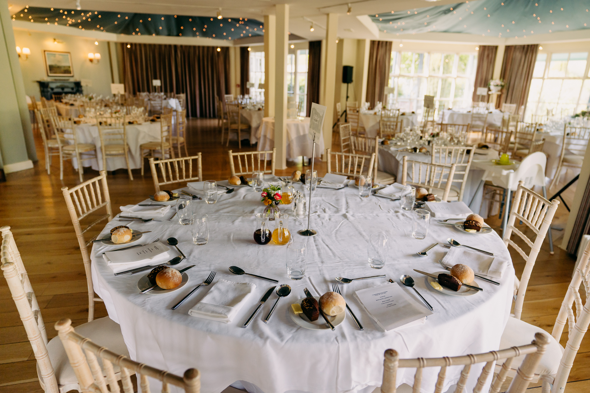 A large dining room with tables set for a meal