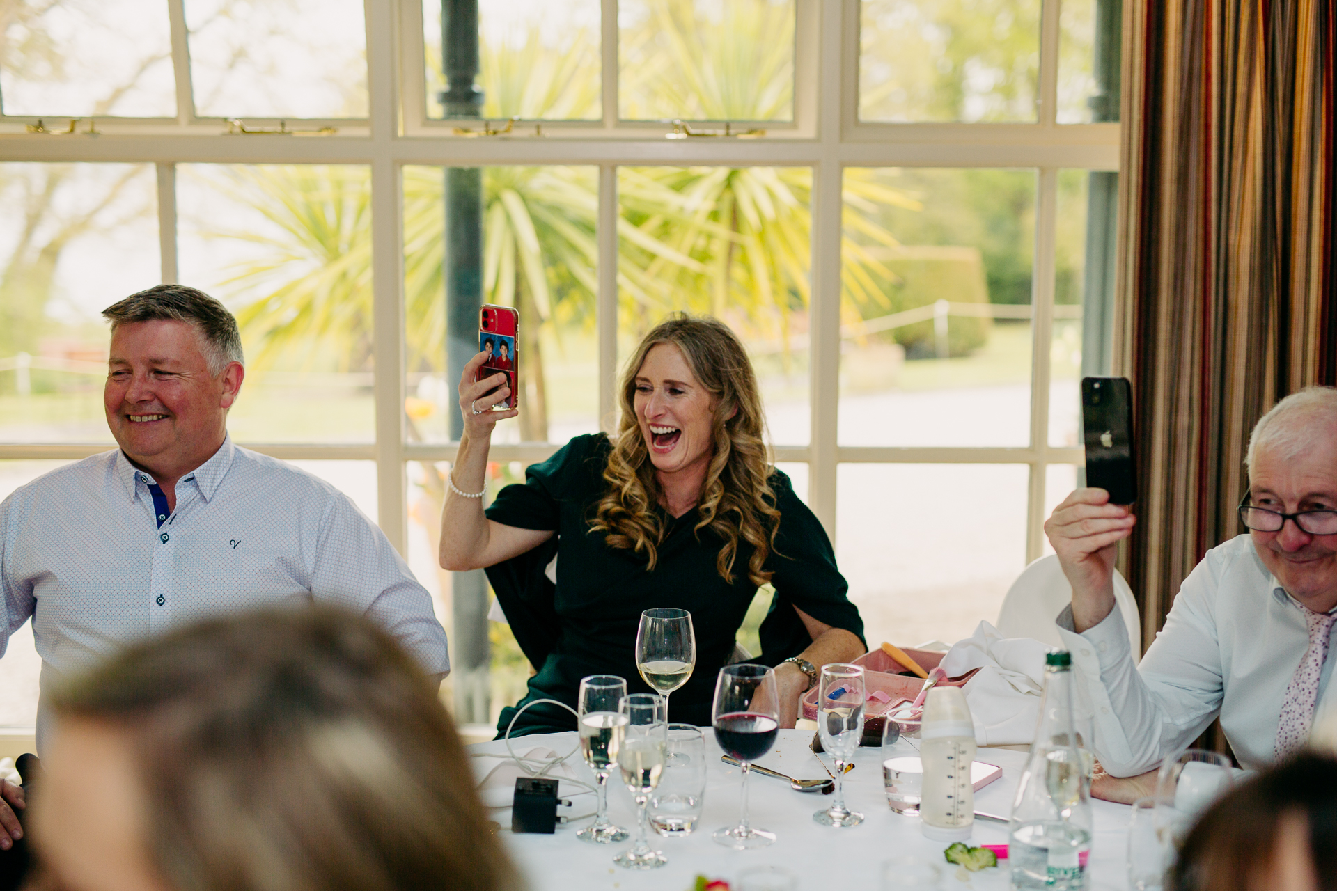 A group of people sitting around a table with wine glasses