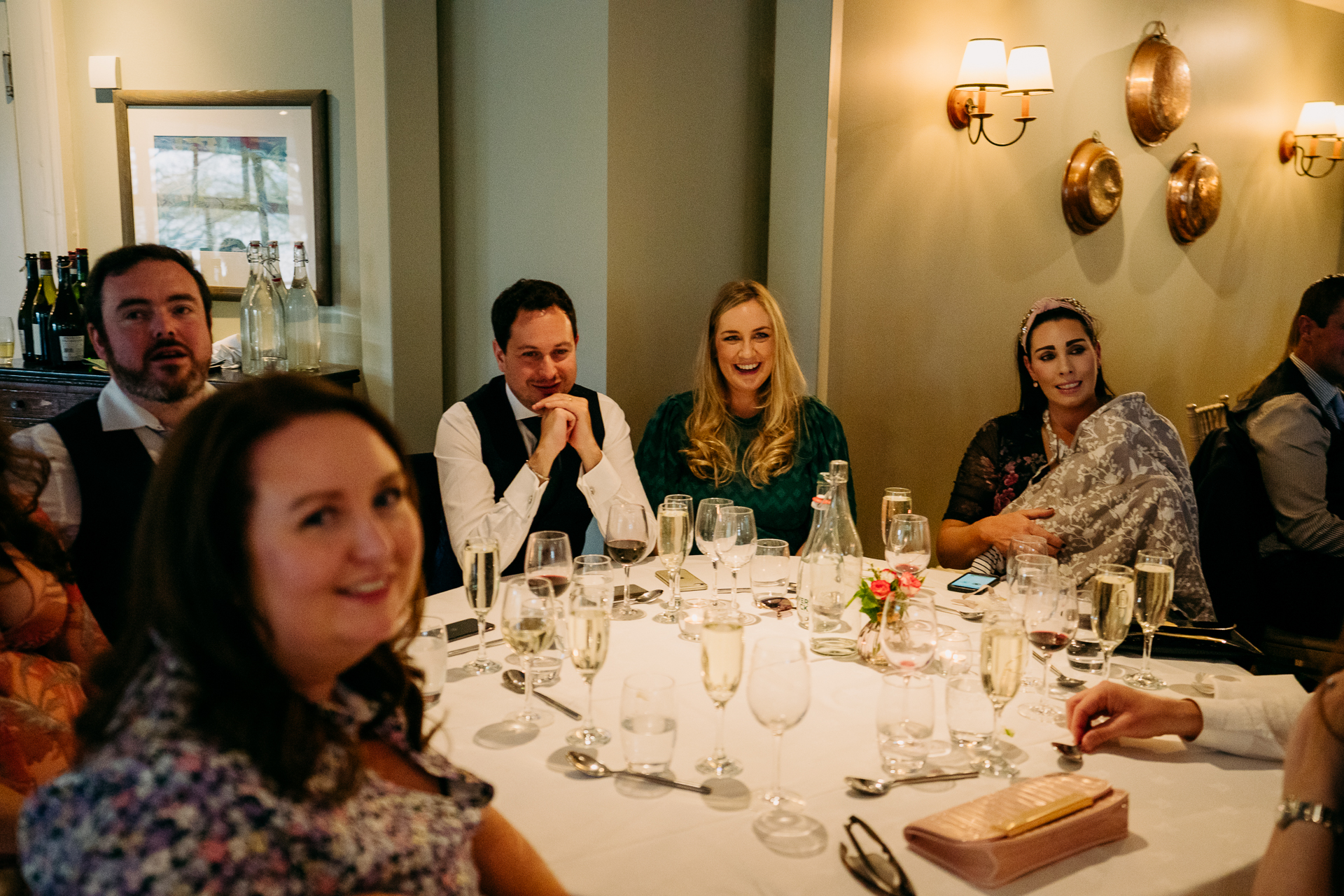 A group of people sitting around a table with wine glasses