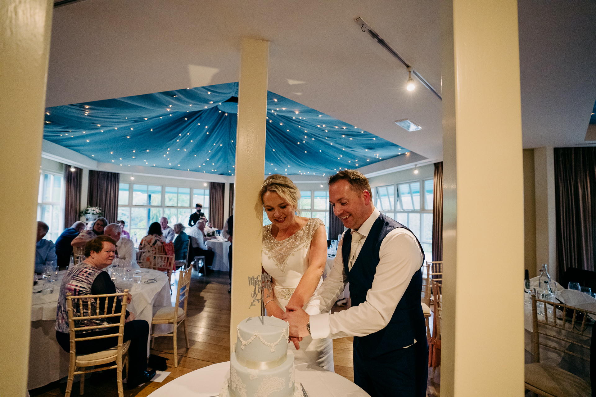 A bride and groom cutting their wedding cake