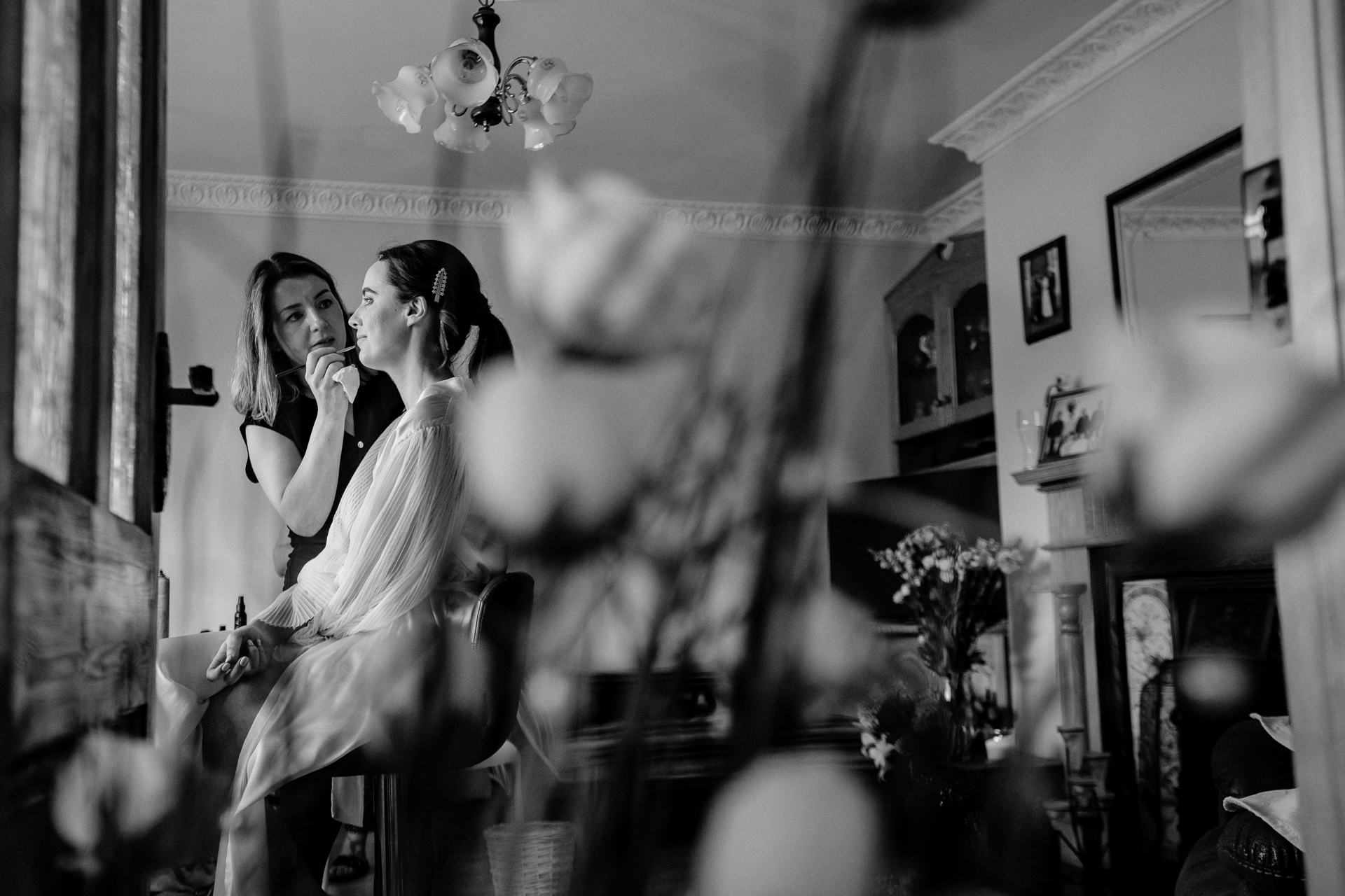 A black and white photo of a woman and a man in a room