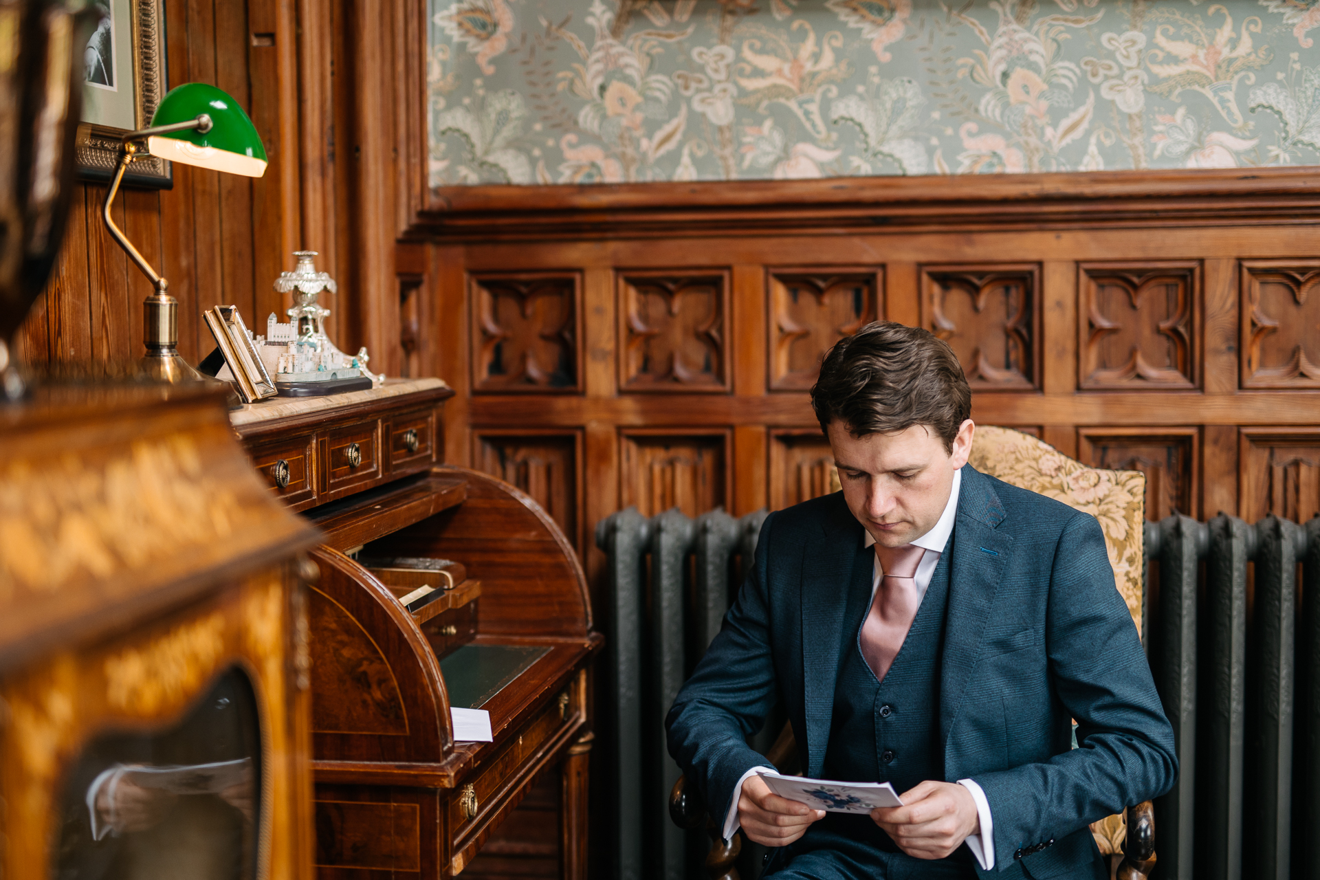 A man sitting in a chair looking at a phone