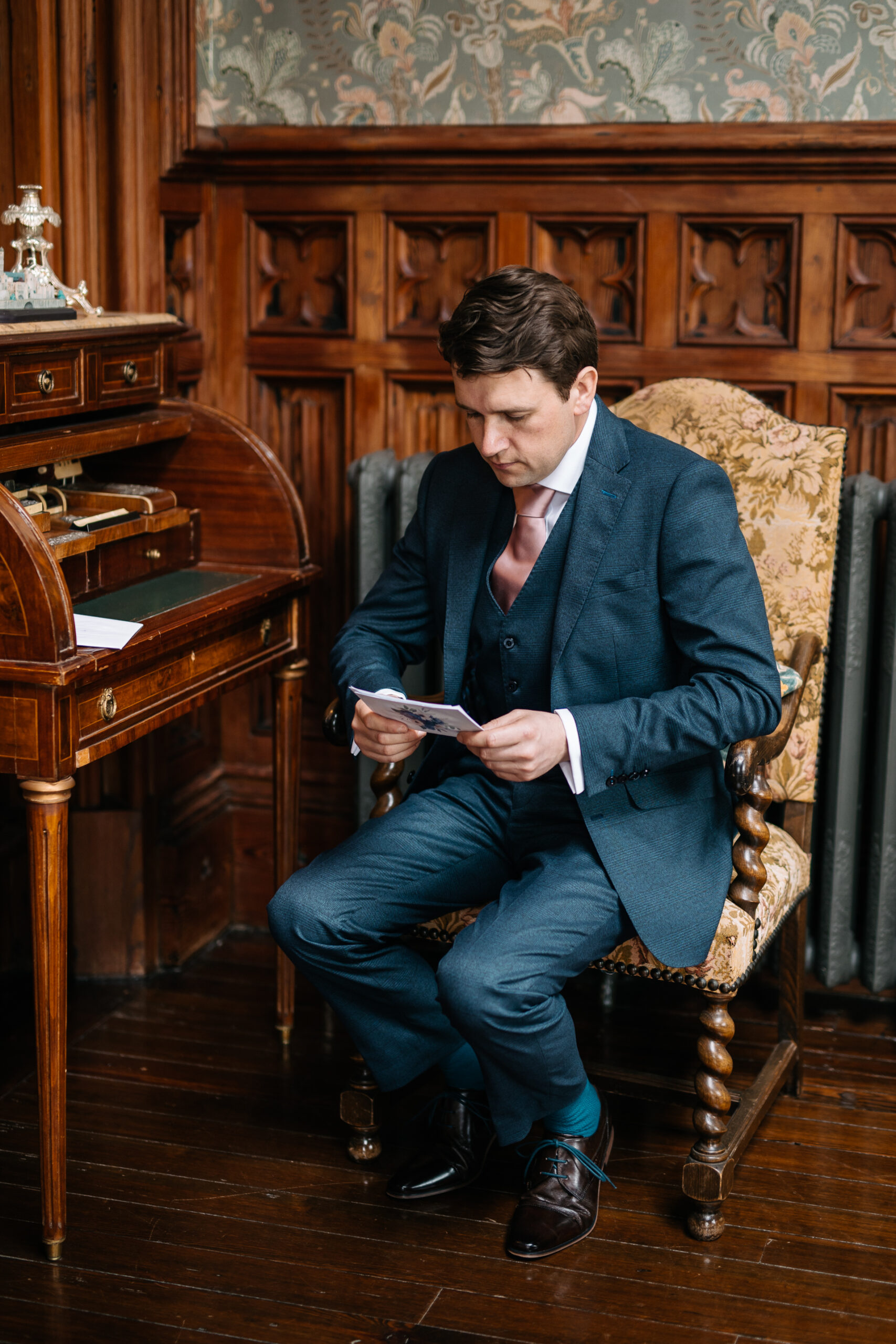 A person sitting in a chair looking at a phone